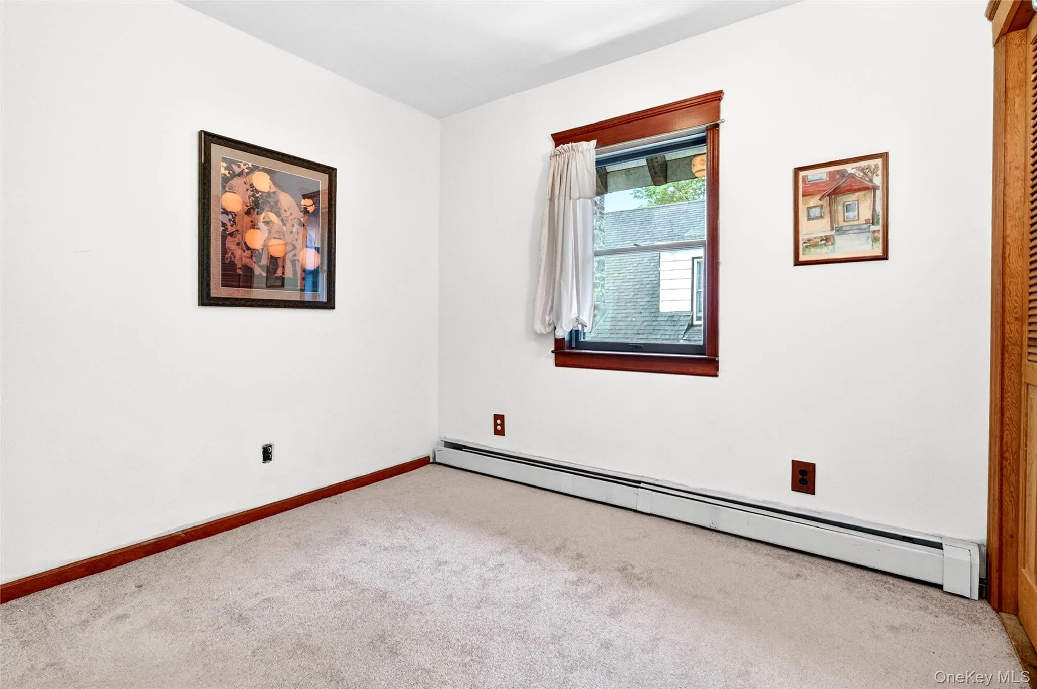 Windowed interior space featuring light-toned carpeting and white wall finishes Windowed interior space featuring light-toned carpeting and white wall finishes
