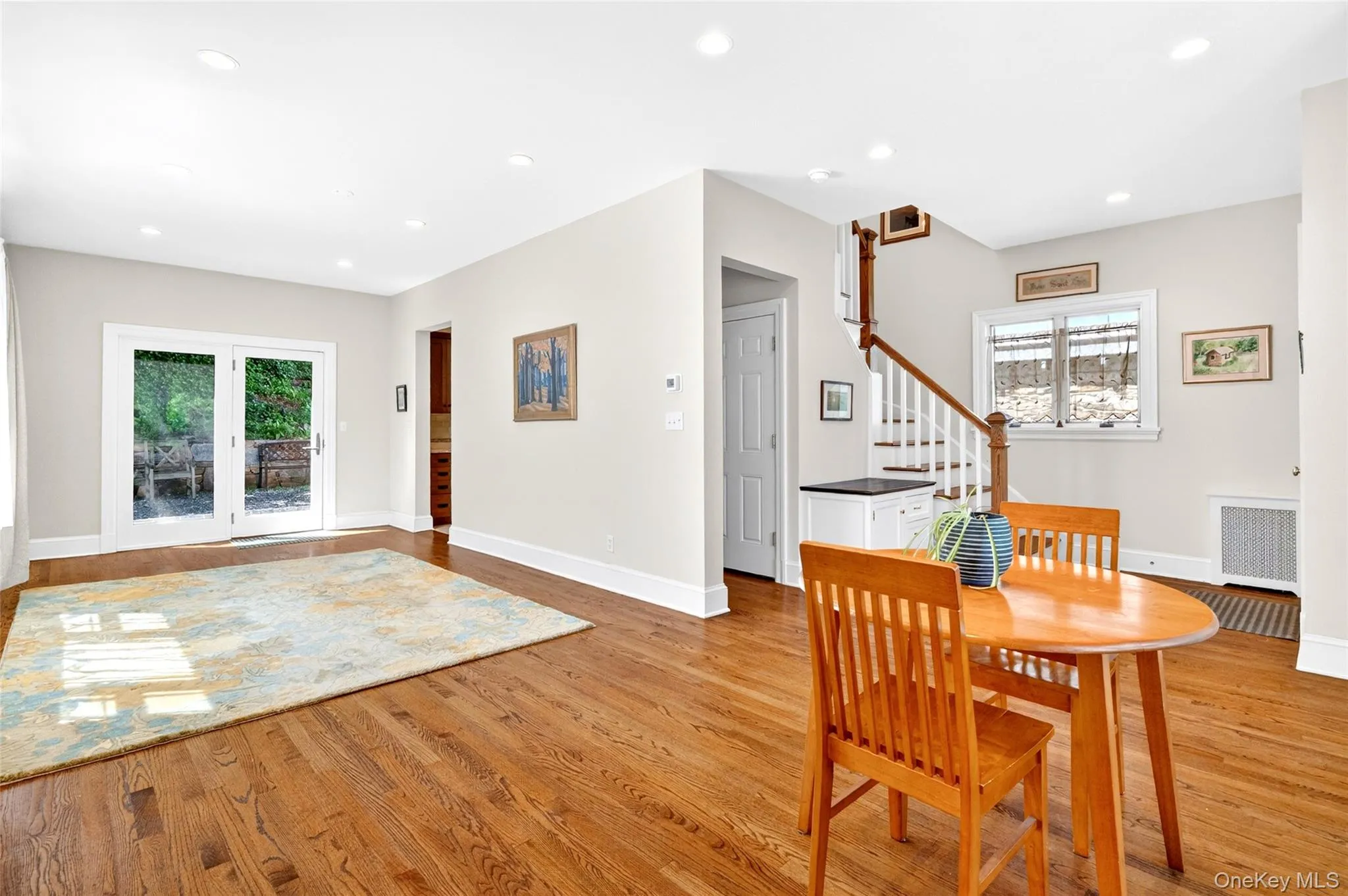 Hardwood flooring throughout, recessed lighting, and white baseboards Hardwood flooring throughout, recessed lighting, and white baseboards