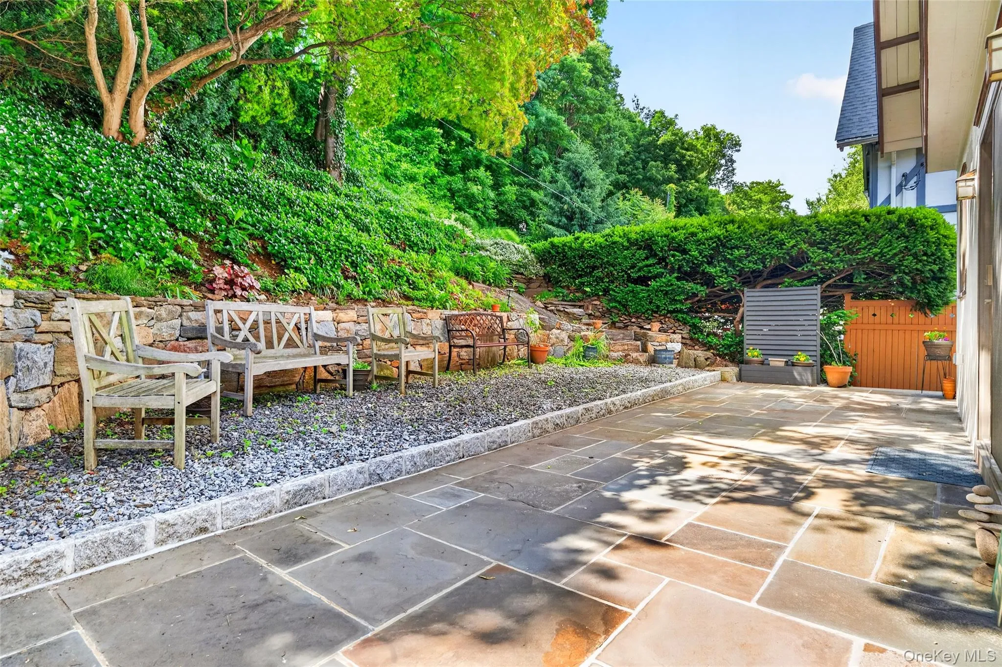 Expansive stone patio featuring large format pavers and a gravel border Expansive stone patio featuring large format pavers and a gravel border