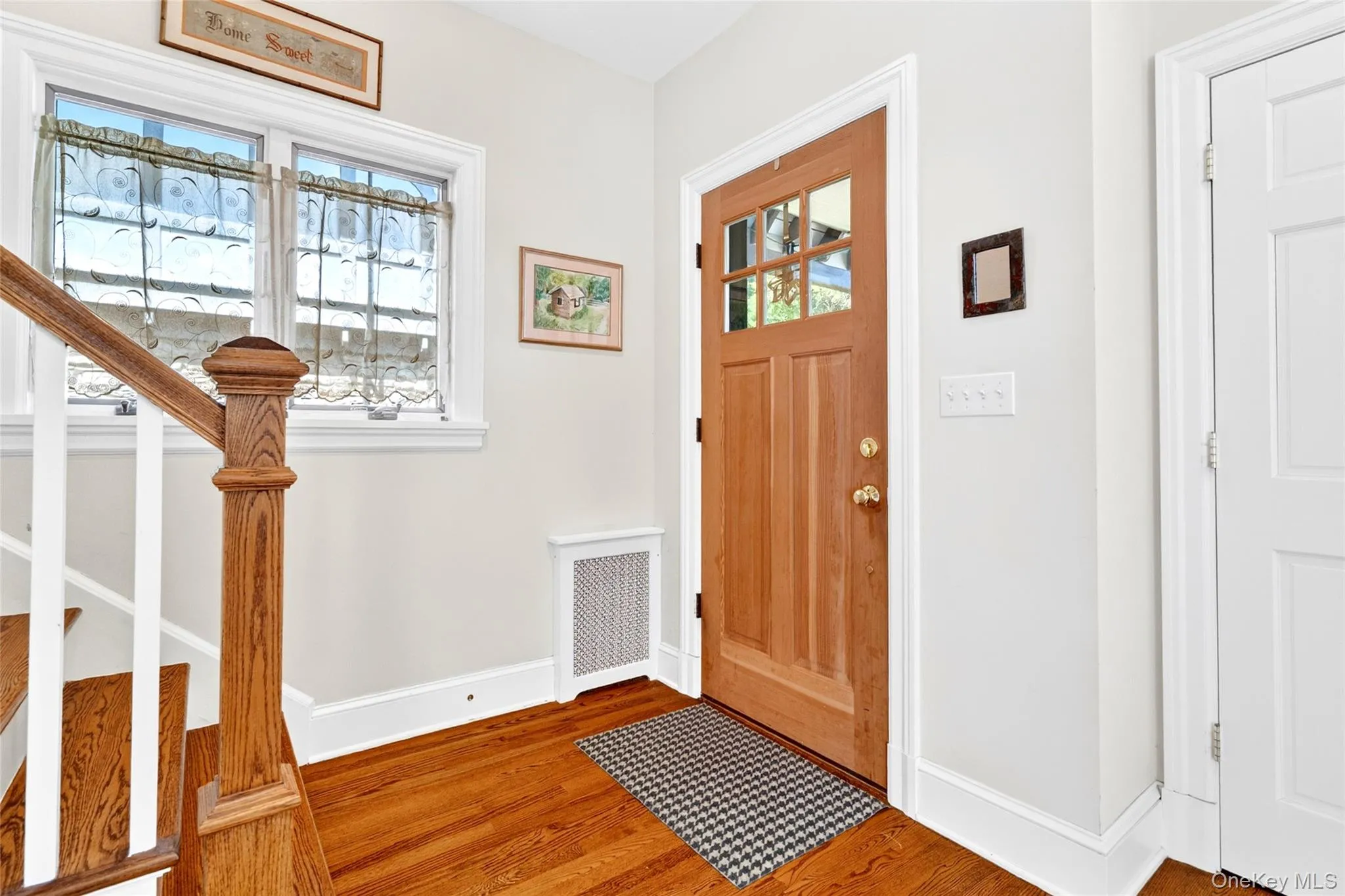 Hardwood flooring in a rich wood-finish extends through the entryway Hardwood flooring in a rich wood-finish extends through the entryway