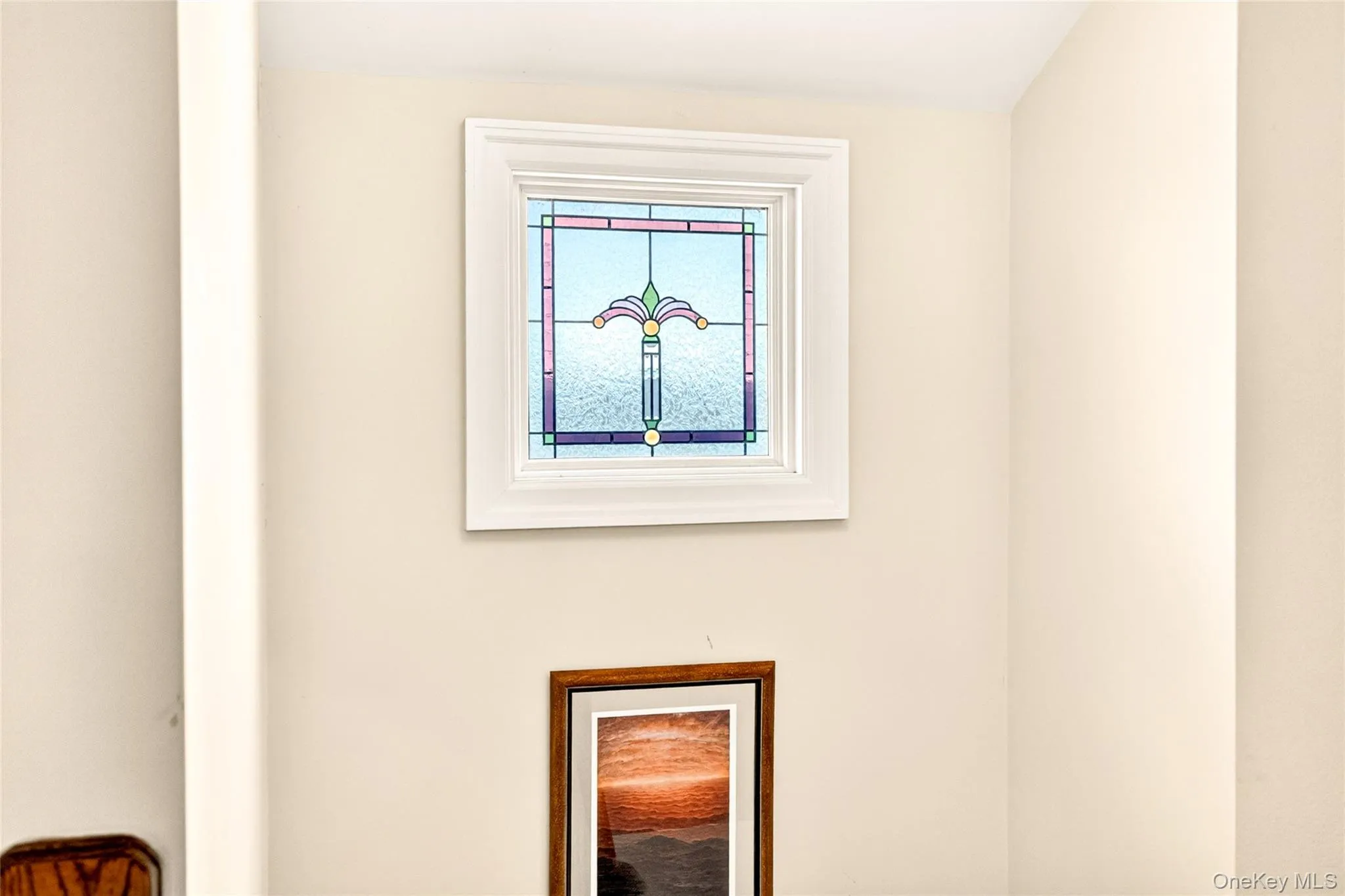 Decorative stained-glass window with white trim Decorative stained-glass window with white trim