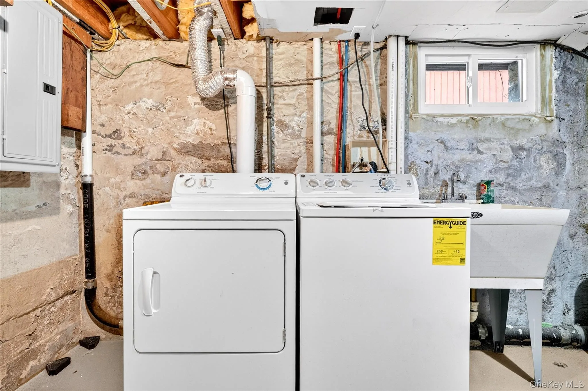 Dedicated laundry area featuring a white washing machine and dryer set Dedicated laundry area featuring a white washing machine and dryer set