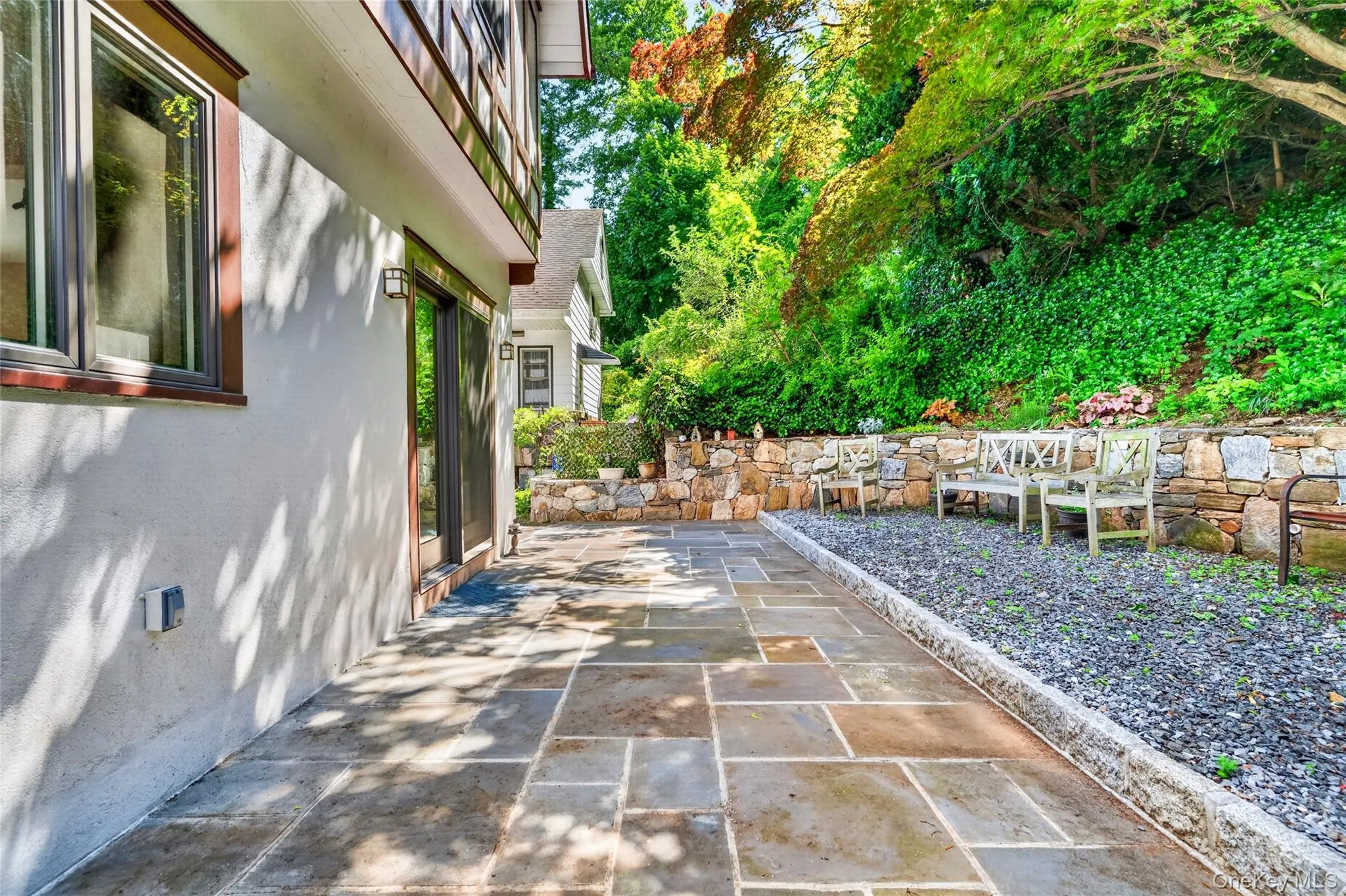 Expansive stone patio featuring large format pavers Expansive stone patio featuring large format pavers