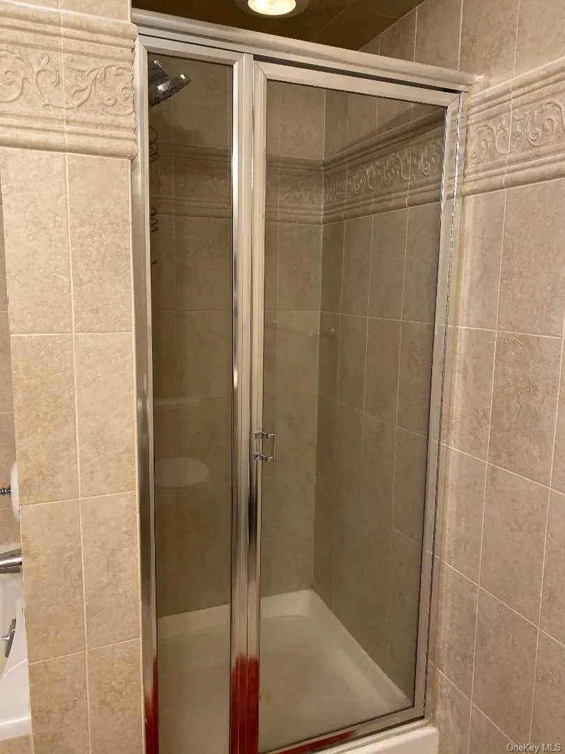 Bathroom featuring a shower stall Bathroom featuring a shower stall