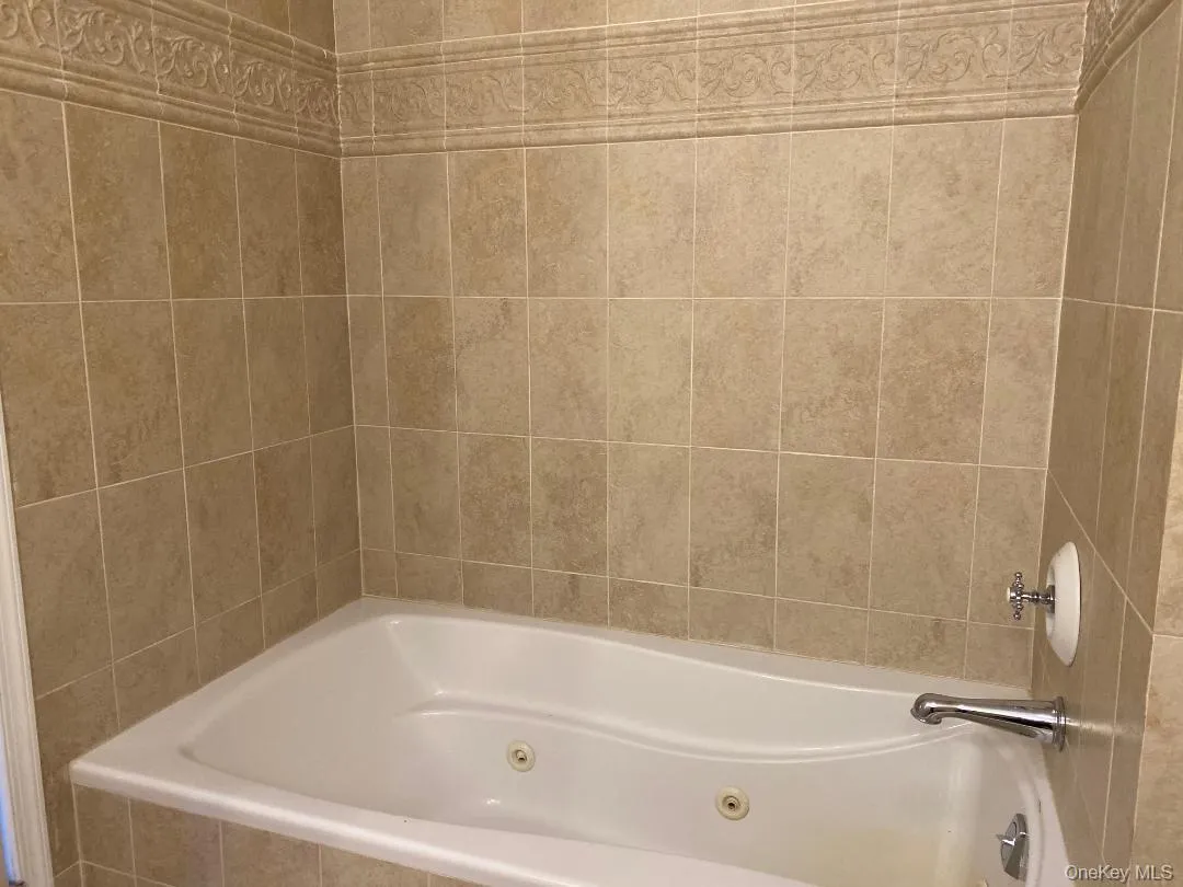 Full bath featuring a jetted tub Full bath featuring a jetted tub