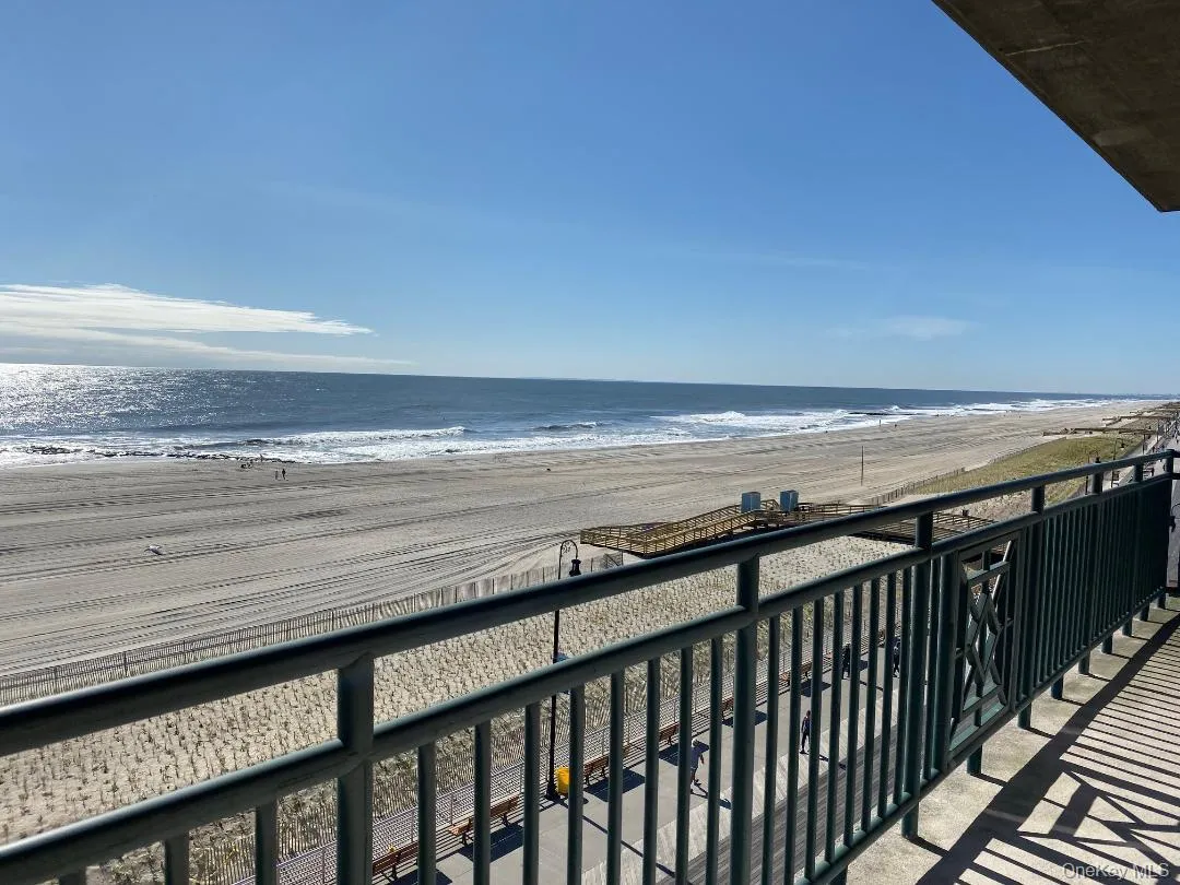 Balcony featuring a water view and a view of the beach Balcony featuring a water view and a view of the beach