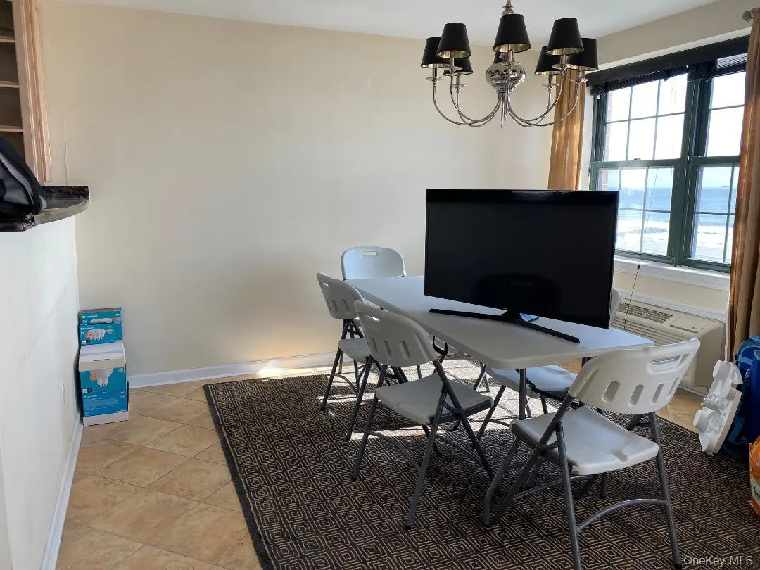 Office with a chandelier, baseboards, and light tile patterned floors Office with a chandelier, baseboards, and light tile patterned floors