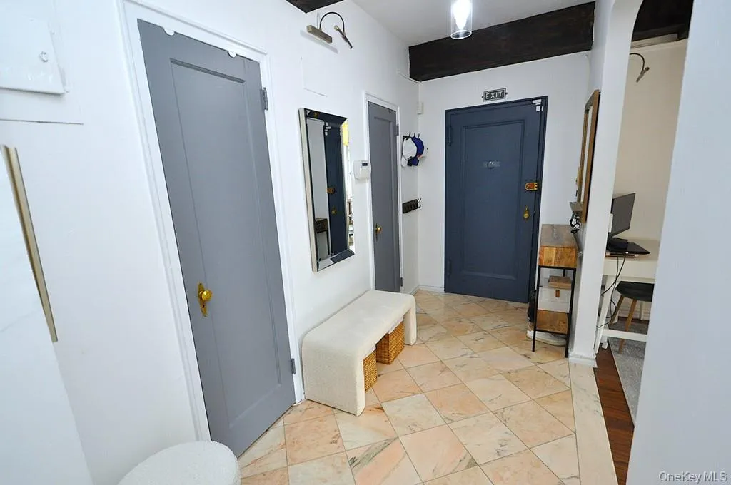 A stunning marble-floored entry welcomes you into a light-filled home featuring charming courtyard views, soaring wood-beamed ceilings, gleaming hardwood floors, and an impressive eight oversized closets for exceptional storage. A stunning marble-floored entry welcomes you into a light-filled home featuring charming courtyard views, soaring wood-beamed ceilings, gleaming hardwood floors, and an impressive eight oversized closets for exceptional storage.