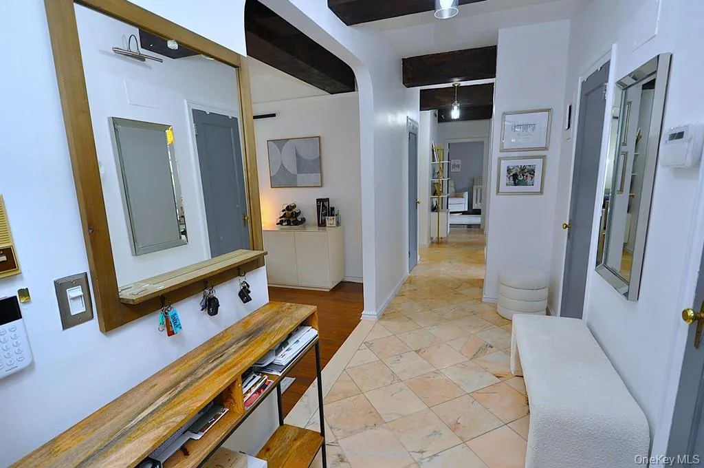 A stunning marble-floored entry welcomes you into a light-filled home featuring charming courtyard views, soaring wood-beamed ceilings, gleaming hardwood floors, and an impressive eight oversized closets for exceptional storage. A stunning marble-floored entry welcomes you into a light-filled home featuring charming courtyard views, soaring wood-beamed ceilings, gleaming hardwood floors, and an impressive eight oversized closets for exceptional storage.