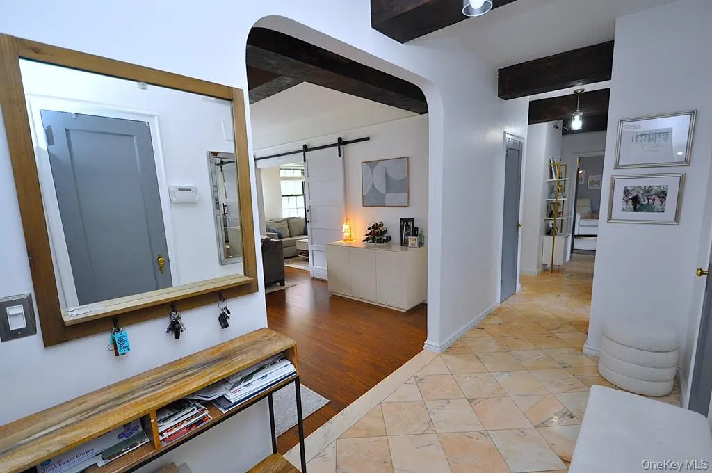 A stunning marble-floored entry welcomes you into a light-filled home featuring charming courtyard views, soaring wood-beamed ceilings, gleaming hardwood floors, and an impressive eight oversized closets for exceptional storage. A stunning marble-floored entry welcomes you into a light-filled home featuring charming courtyard views, soaring wood-beamed ceilings, gleaming hardwood floors, and an impressive eight oversized closets for exceptional storage.