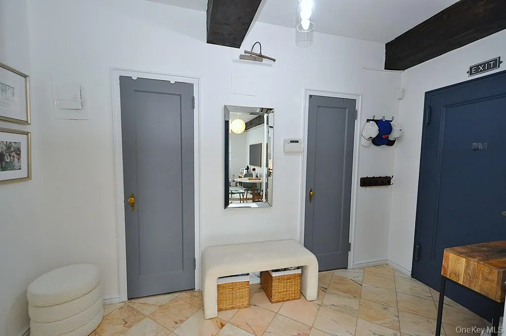 A stunning marble-floored entry welcomes you into a light-filled home featuring charming courtyard views, soaring wood-beamed ceilings, gleaming hardwood floors, and an impressive eight oversized closets for exceptional storage. A stunning marble-floored entry welcomes you into a light-filled home featuring charming courtyard views, soaring wood-beamed ceilings, gleaming hardwood floors, and an impressive eight oversized closets for exceptional storage.
