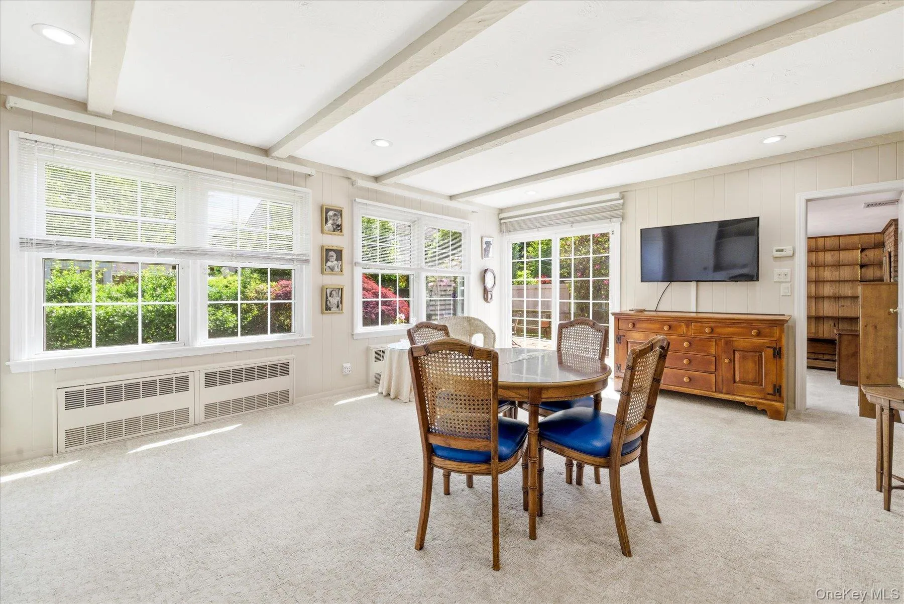 Bright family room featuring a beamed ceiling and recessed lighting which leads into the office. Bright family room featuring a beamed ceiling and recessed lighting which leads into the office.