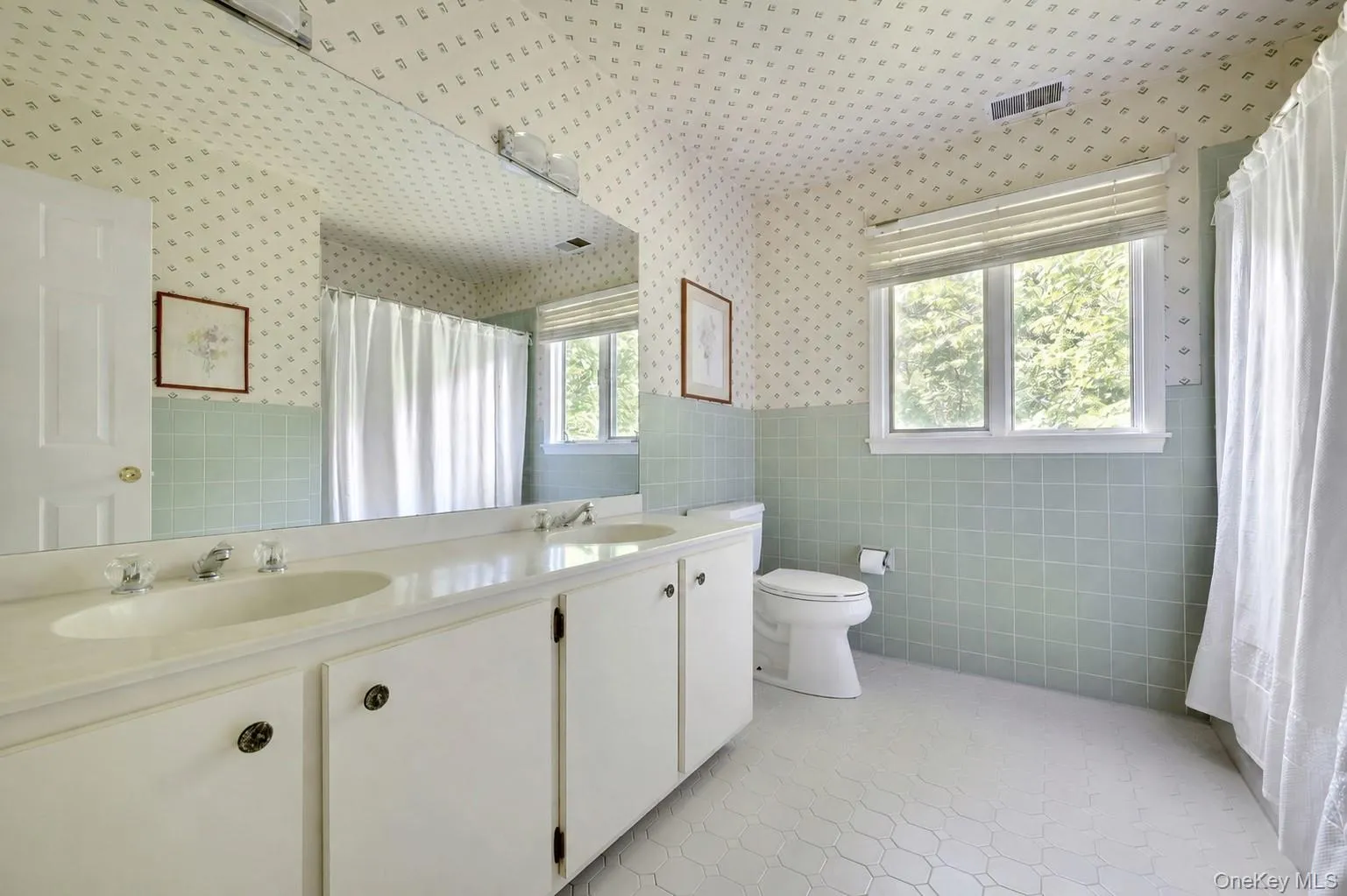 Hall bathroom on second level with dual sink vanity. Hall bathroom on second level with dual sink vanity.