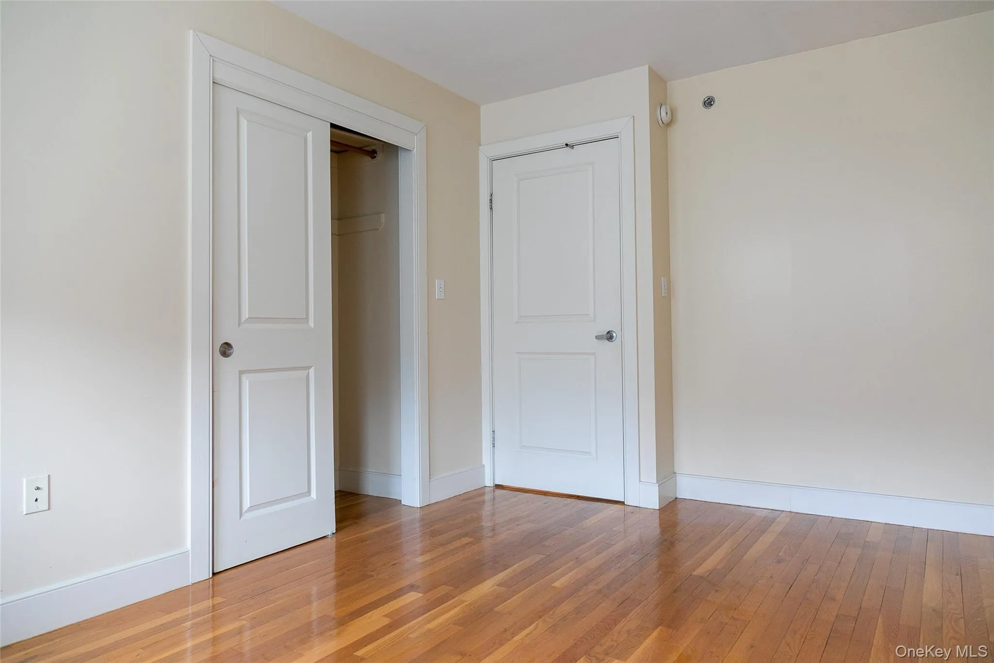 Hardwood flooring spanning the room, complemented by neutral wall tones Hardwood flooring spanning the room, complemented by neutral wall tones