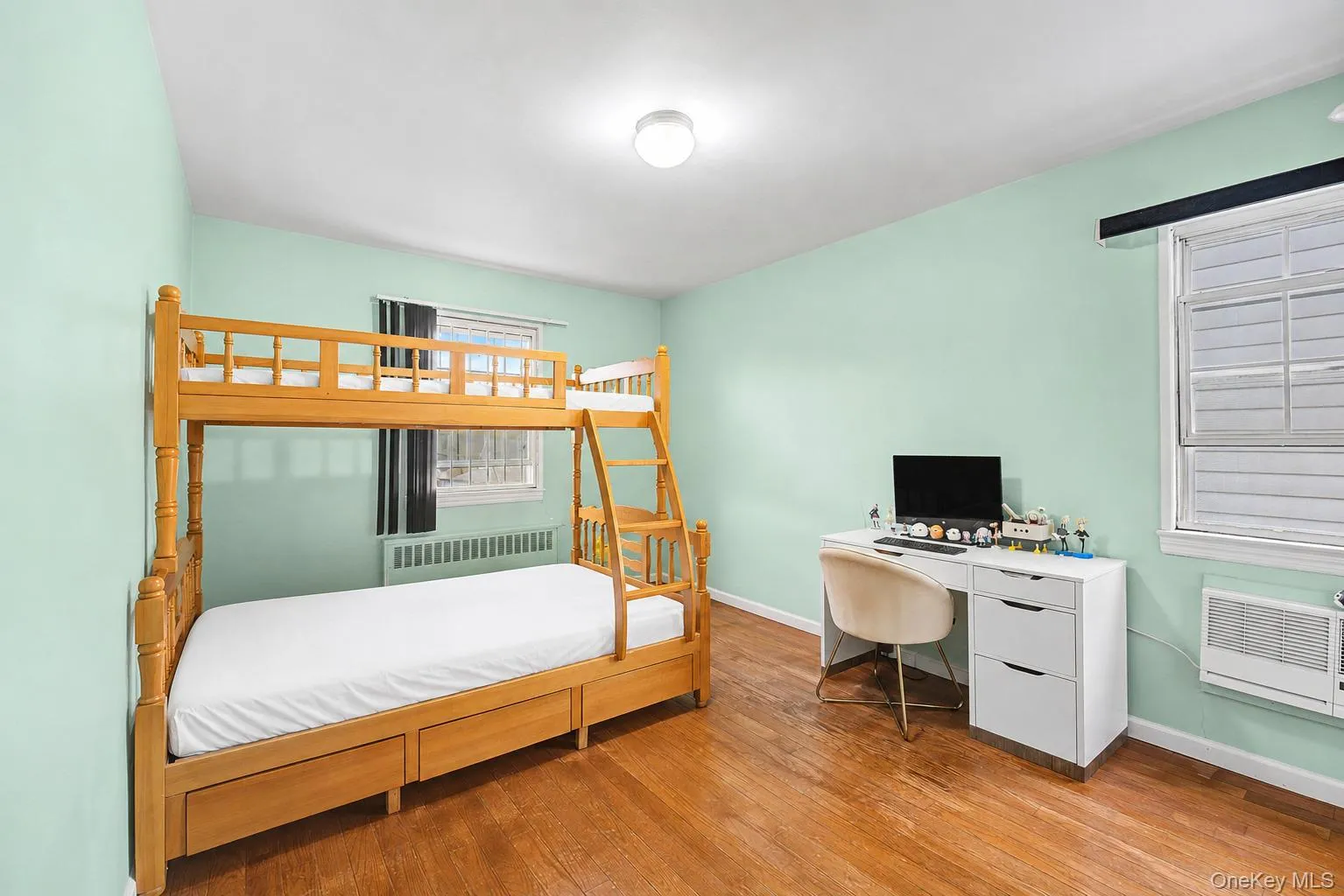 Hardwood flooring complements light green walls and white trim Hardwood flooring complements light green walls and white trim