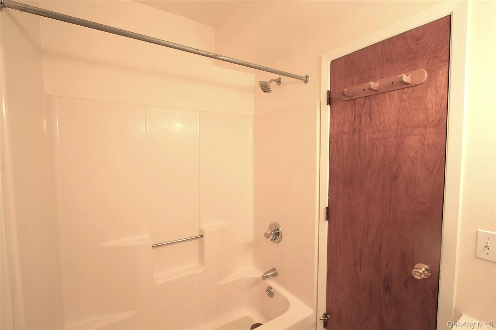 The bathroom has a tub and shower, with an easy to clean surround and great shower head. The bathroom has a tub and shower, with an easy to clean surround and great shower head.