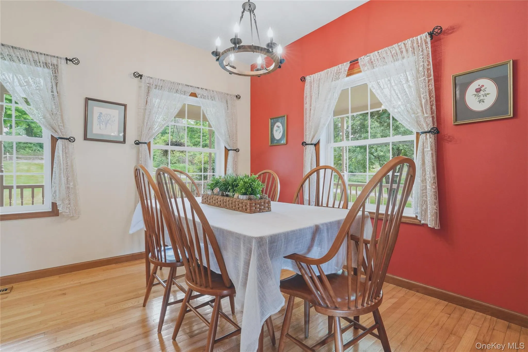 Dining room with wood floor and coral walls Dining room with wood floor and coral walls