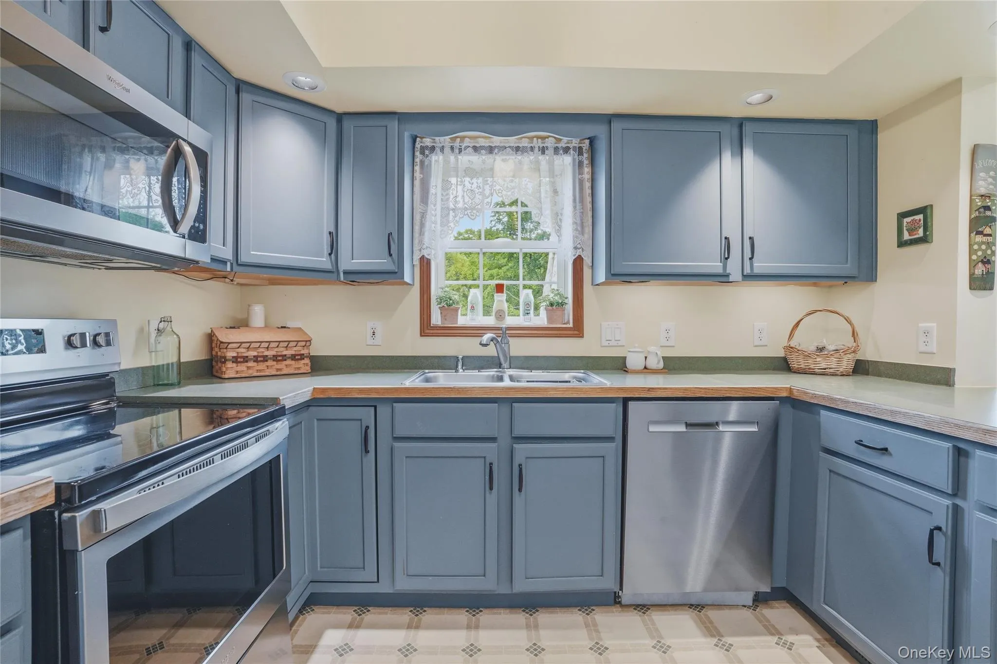 Kitchen with blue cabinets and stainless steal appliances Kitchen with blue cabinets and stainless steal appliances
