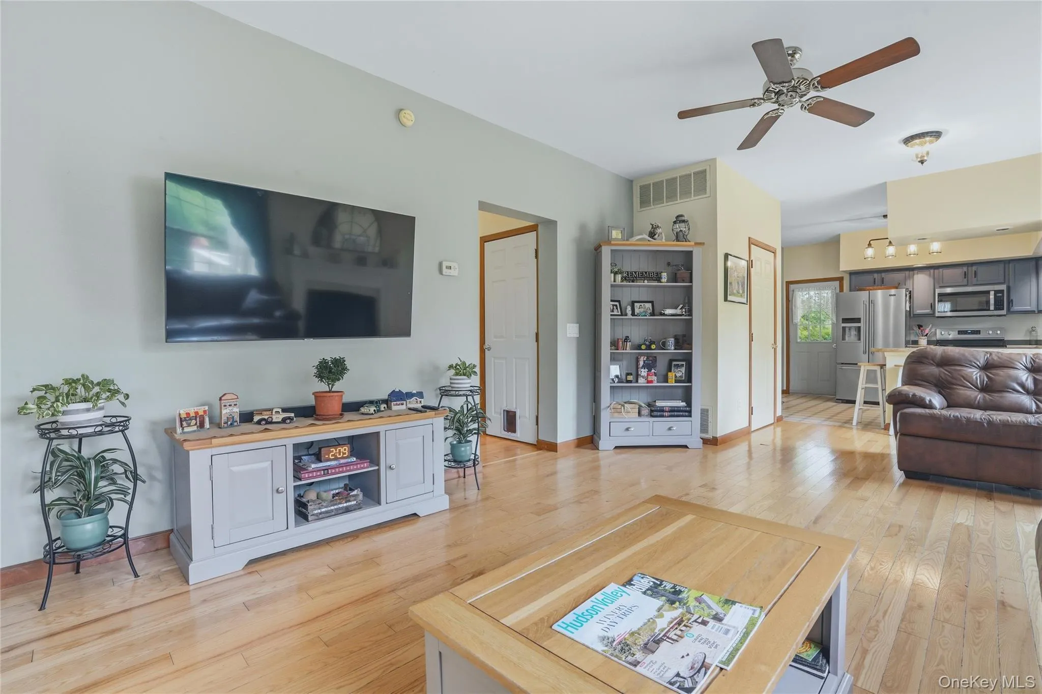 Open living room to kitchen with fireplace and wood floors Open living room to kitchen with fireplace and wood floors