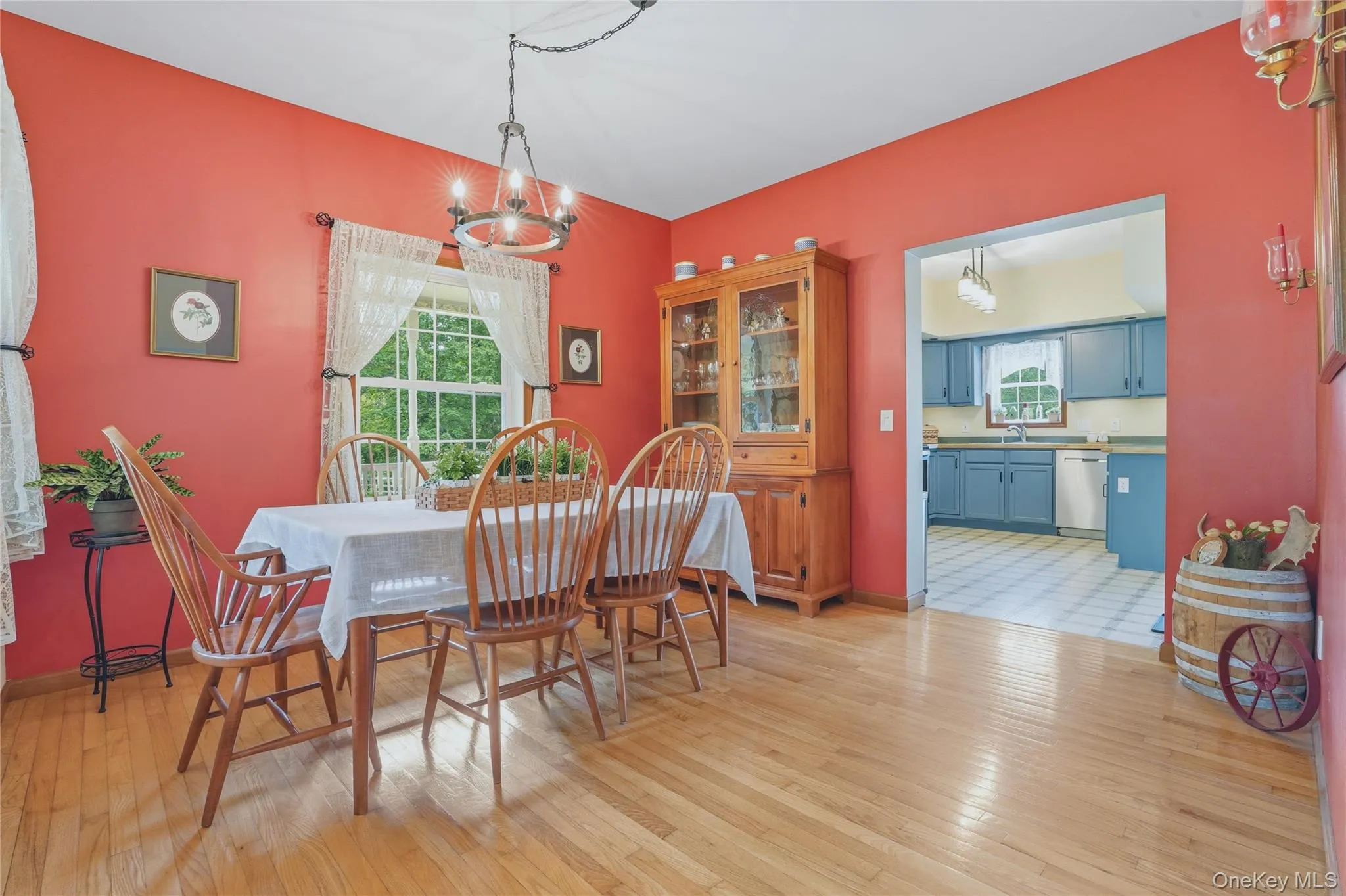 Dining room with wood floor and coral walls Dining room with wood floor and coral walls