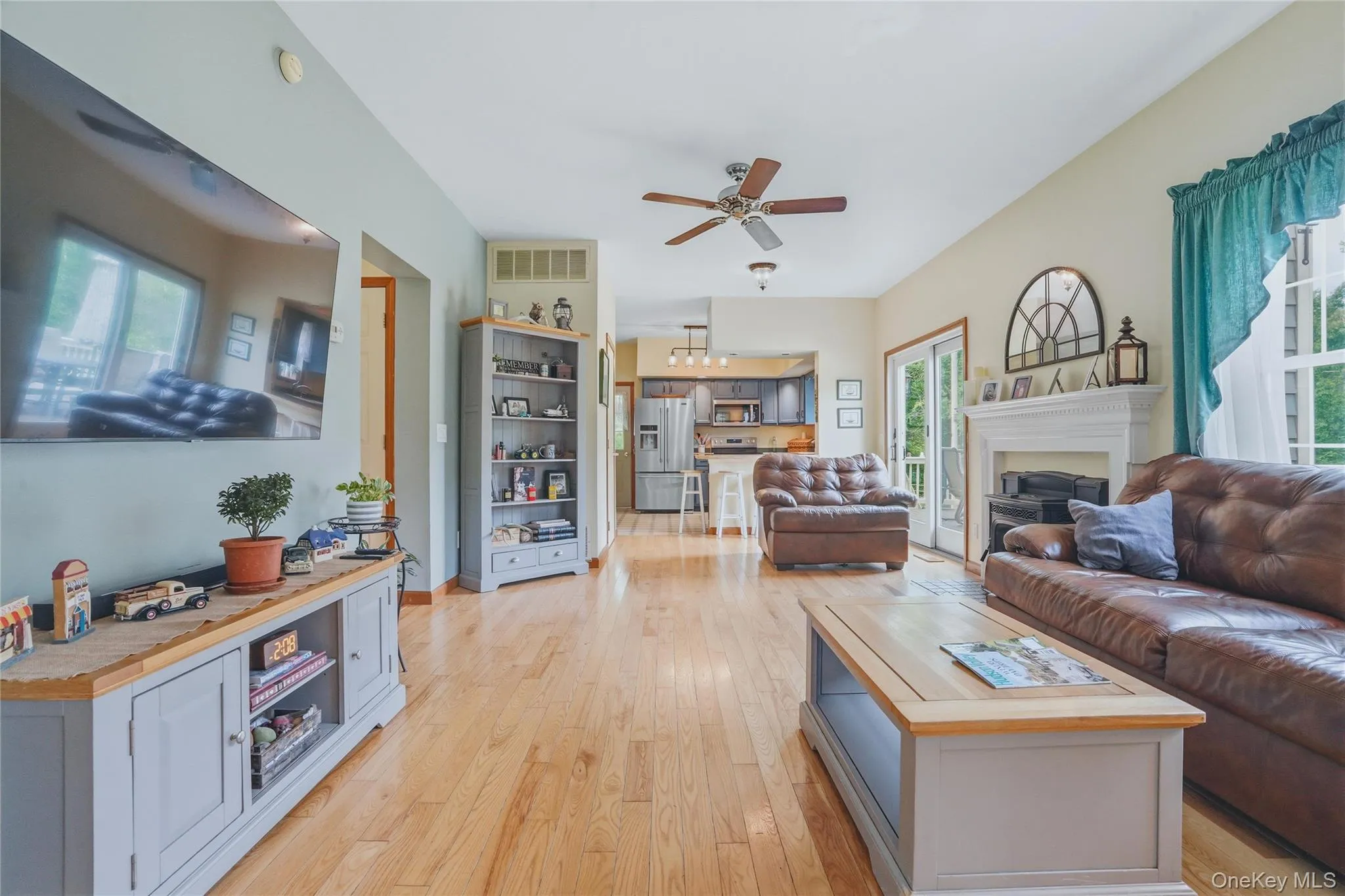 Open living room to kitchen with fireplace and wood floors Open living room to kitchen with fireplace and wood floors