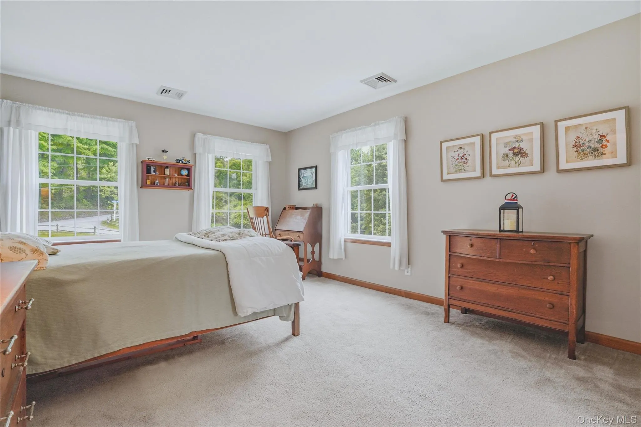 Primary bedroom with accent wall and grey carpet Primary bedroom with accent wall and grey carpet