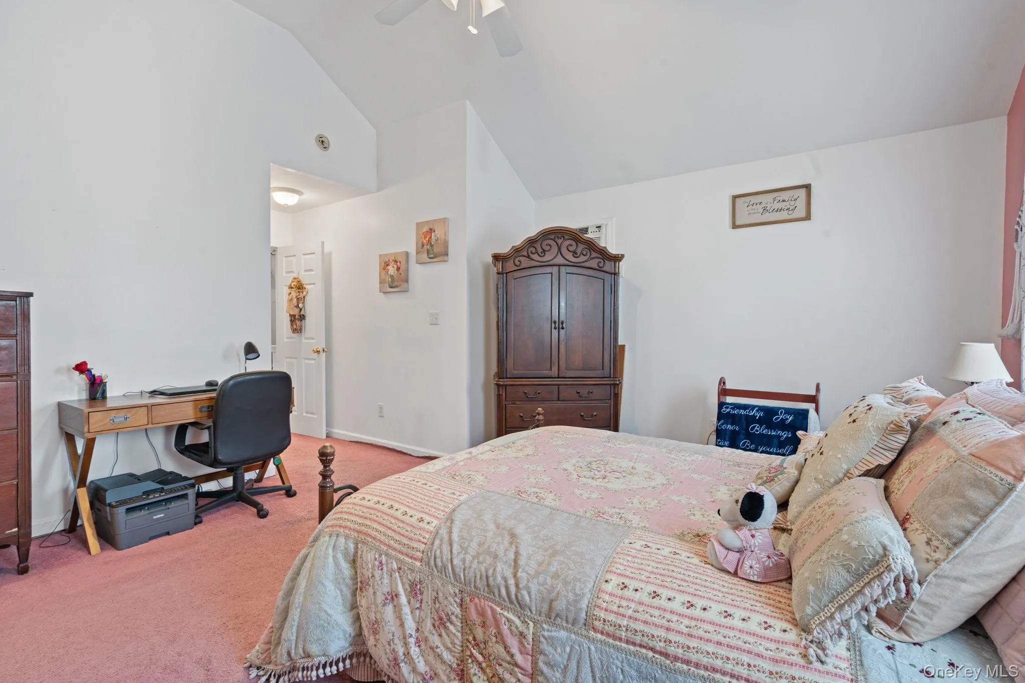 Bedroom featuring a vaulted ceiling, ceiling fan, and plush carpet flooring Bedroom featuring a vaulted ceiling, ceiling fan, and plush carpet flooring