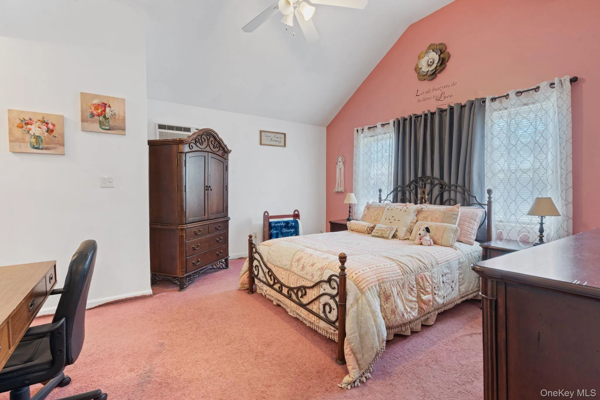 Room featuring a vaulted ceiling with a ceiling fan, dual windows, and an air conditioning unit Room featuring a vaulted ceiling with a ceiling fan, dual windows, and an air conditioning unit