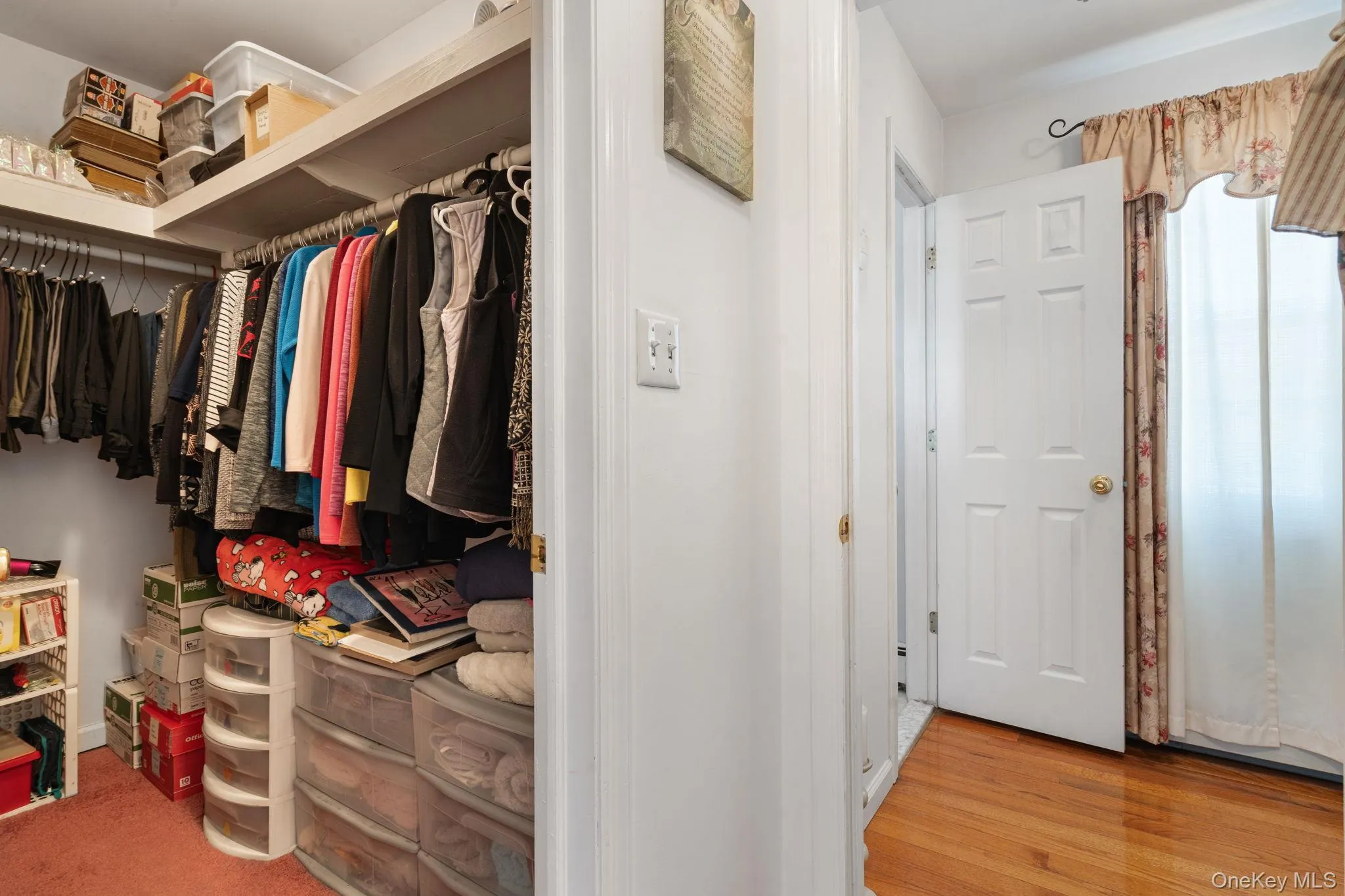 Walk-in closet featuring extensive built-in shelving and dual hanging rods Walk-in closet featuring extensive built-in shelving and dual hanging rods
