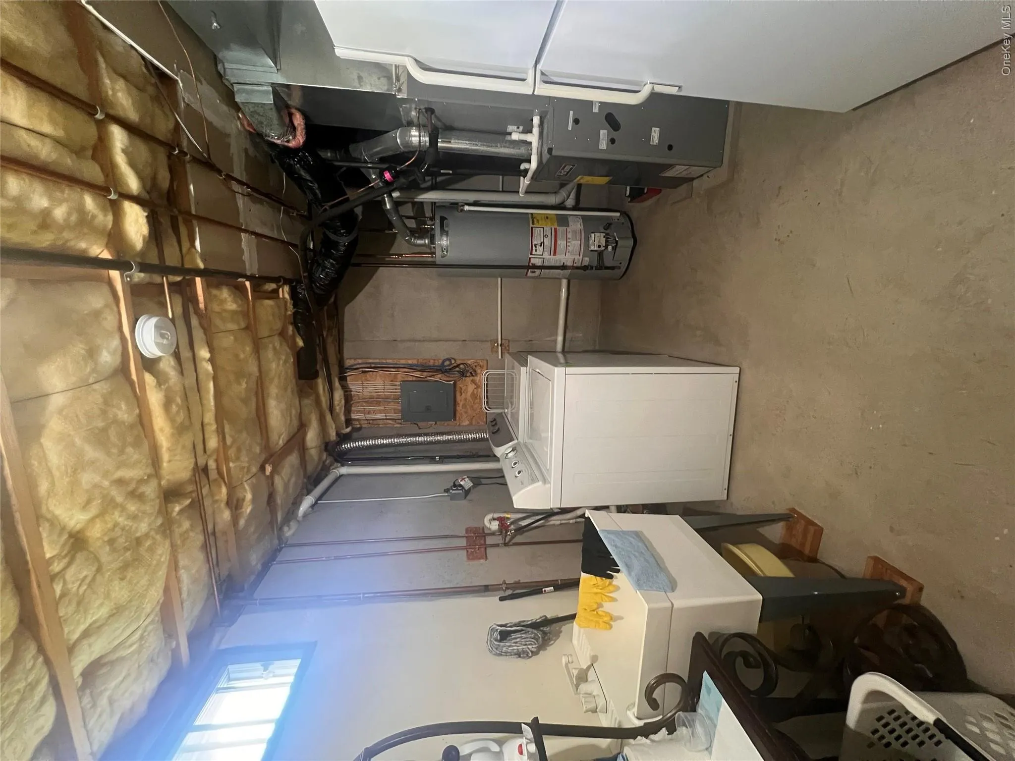 Laundry area with washer dryer units, sink and utility area Laundry area with washer dryer units, sink and utility area
