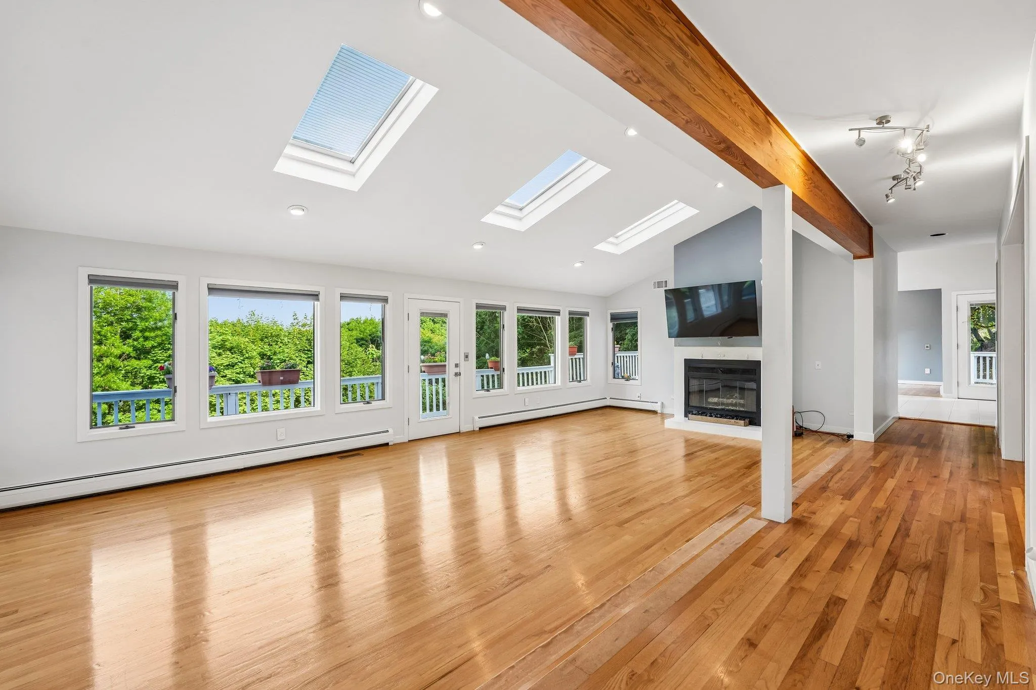 An open-concept living room under a skylight An open-concept living room under a skylight