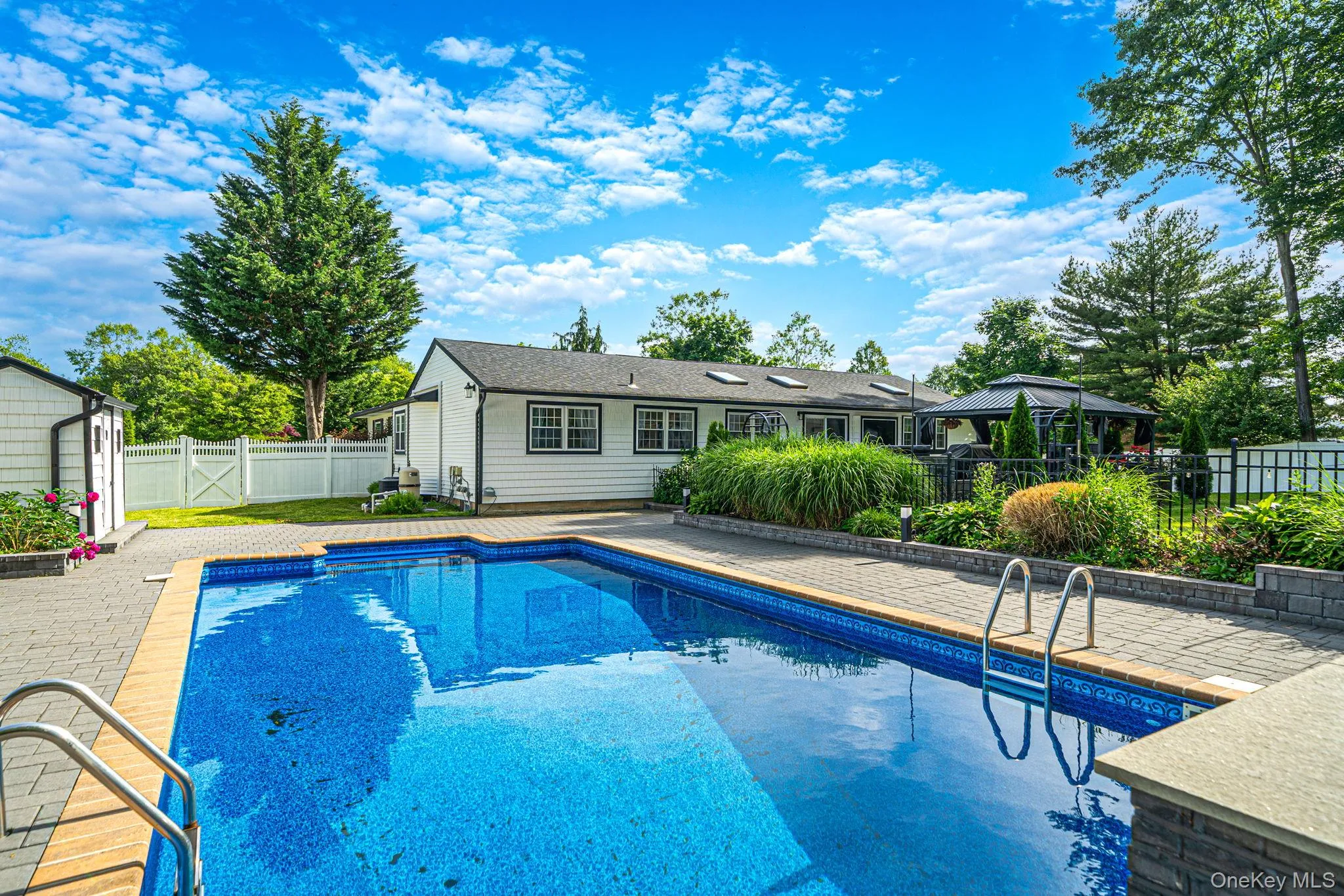 Inground salt water pool with lights and a fountain, expanded brick pool deck, beautiful landscaping, and shed. Inground salt water pool with lights and a fountain, expanded brick pool deck, beautiful landscaping, and shed.