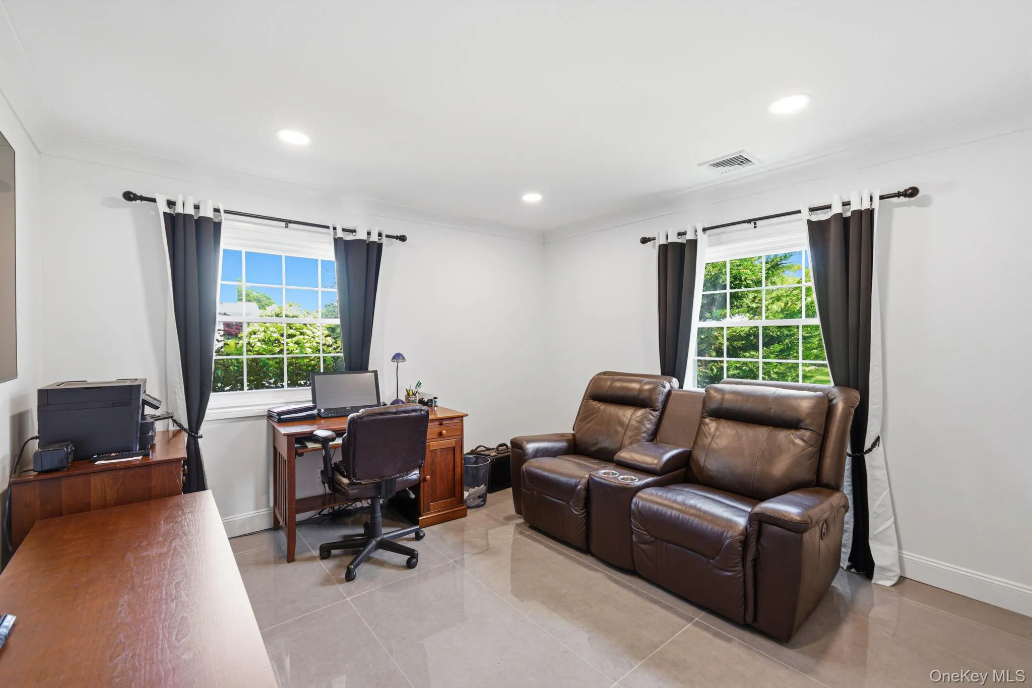Bedroom features 2 windows, recessed lighting, porcelain tile floors, a custom closet. Bedroom features 2 windows, recessed lighting, porcelain tile floors, a custom closet.