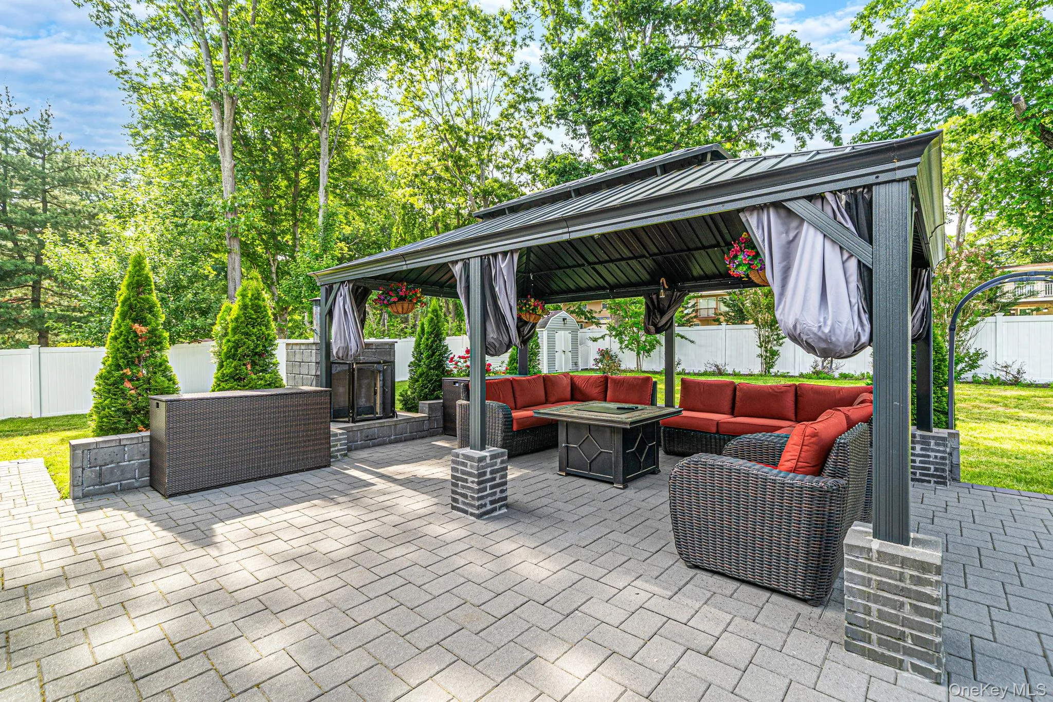 Large brick patio in the backyard features a large gazebo, outside gas fireplace, outdoor kitchen and inground salt water pool. Large brick patio in the backyard features a large gazebo, outside gas fireplace, outdoor kitchen and inground salt water pool.