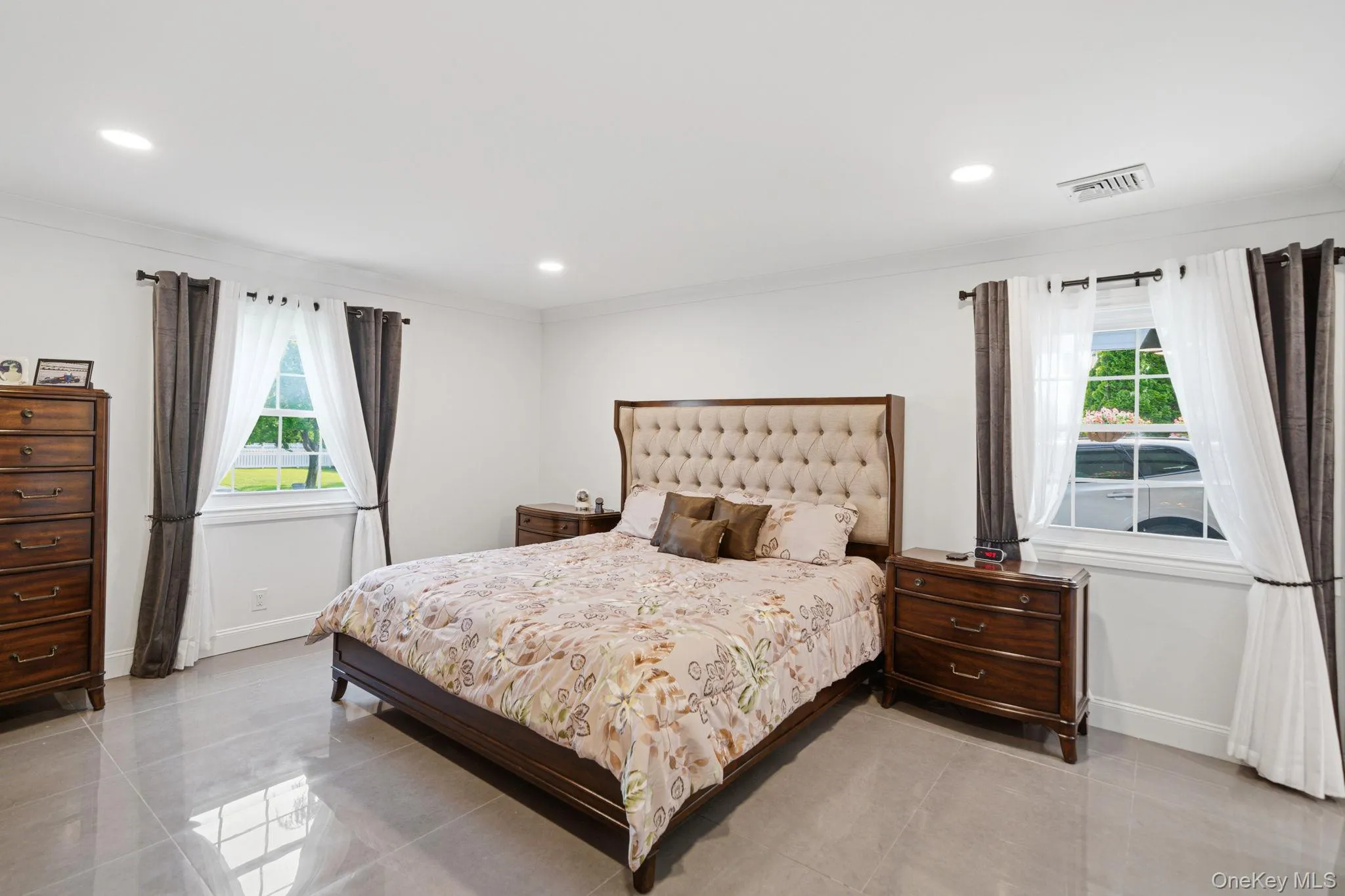 Primary bedroom features 2 windows, recessed lighting, porcelain tile floors, a custom full wall deep closet. Primary bedroom features 2 windows, recessed lighting, porcelain tile floors, a custom full wall deep closet.