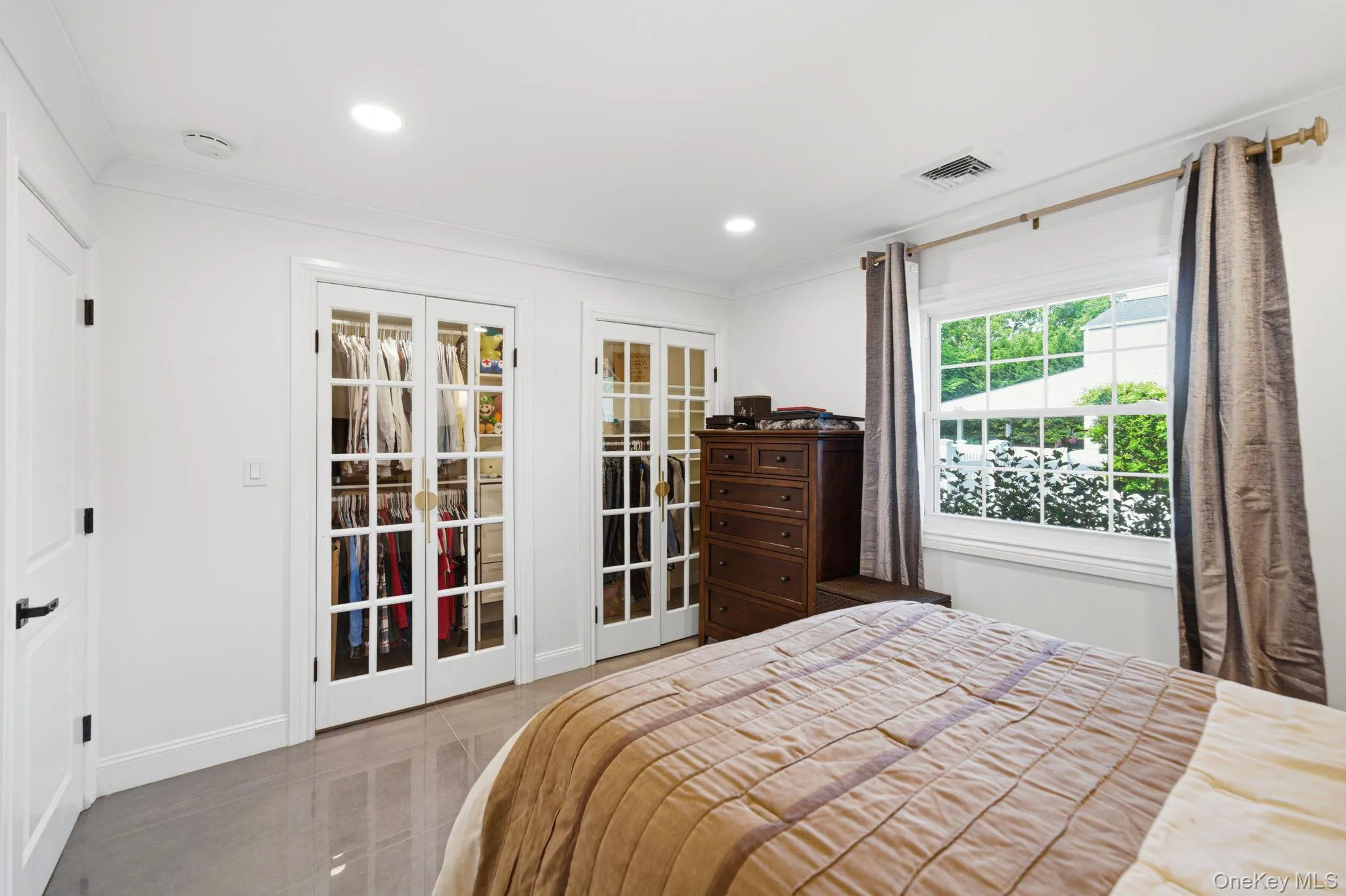 Bedroom features recessed lighting, porcelain tile floors, a custom full wall deep closet. Bedroom features recessed lighting, porcelain tile floors, a custom full wall deep closet.