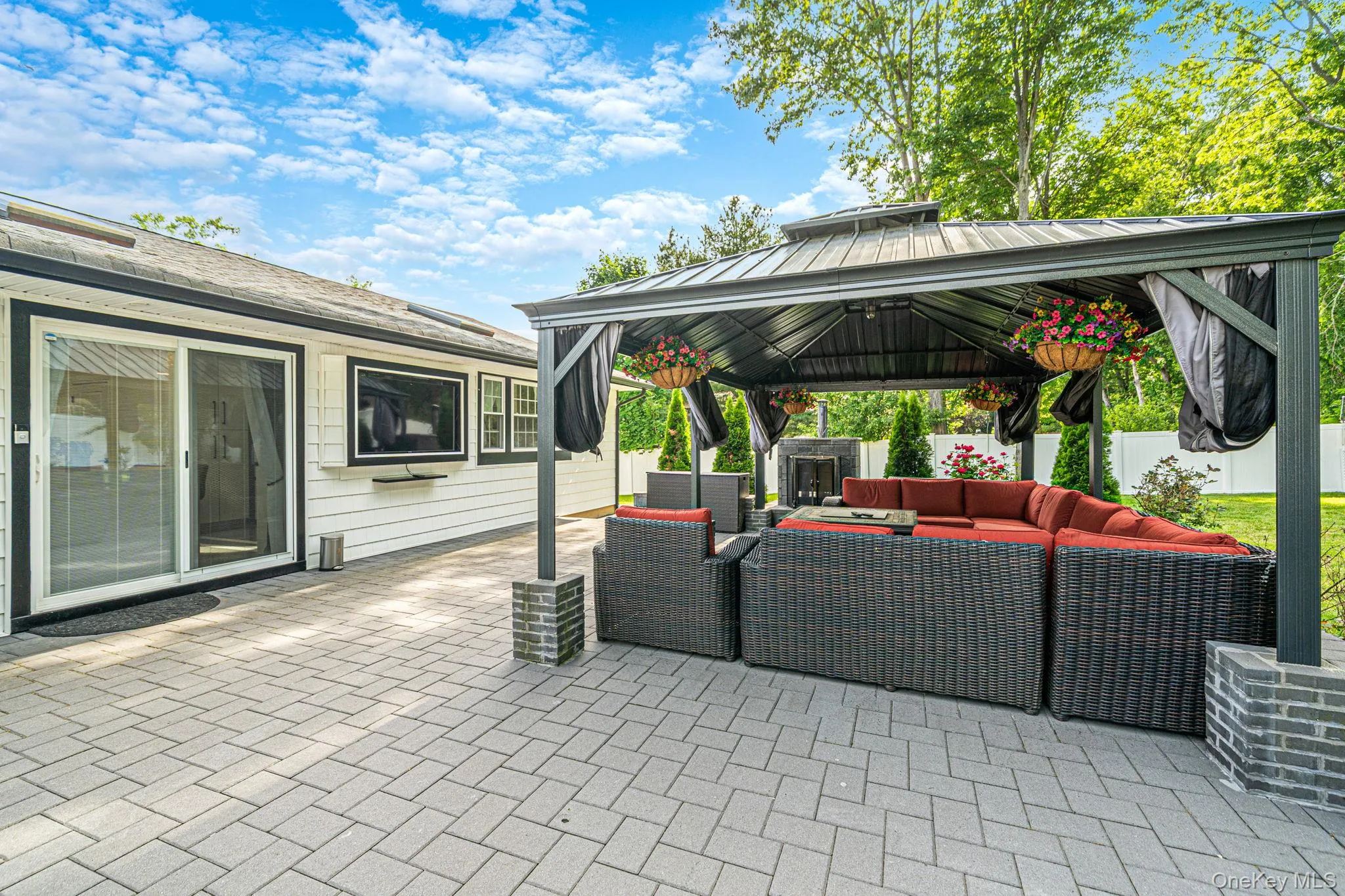 Large brick patio in the backyard features a large gazebo, outside gas fireplace, outdoor kitchen and inground salt water pool. Large brick patio in the backyard features a large gazebo, outside gas fireplace, outdoor kitchen and inground salt water pool.
