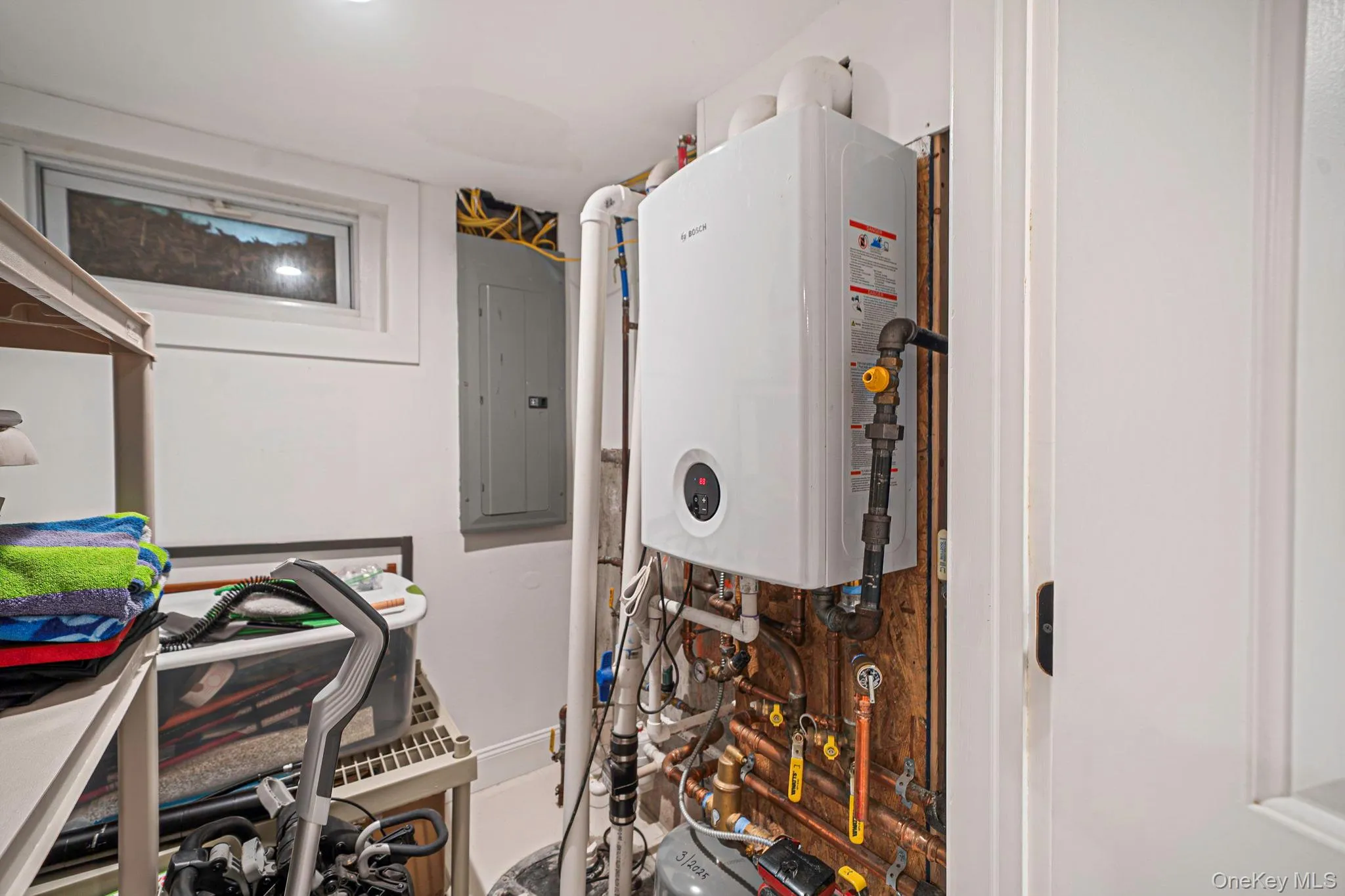 Utility room including high-end tankless water heater provides instant hot water. Utility room including high-end tankless water heater provides instant hot water.