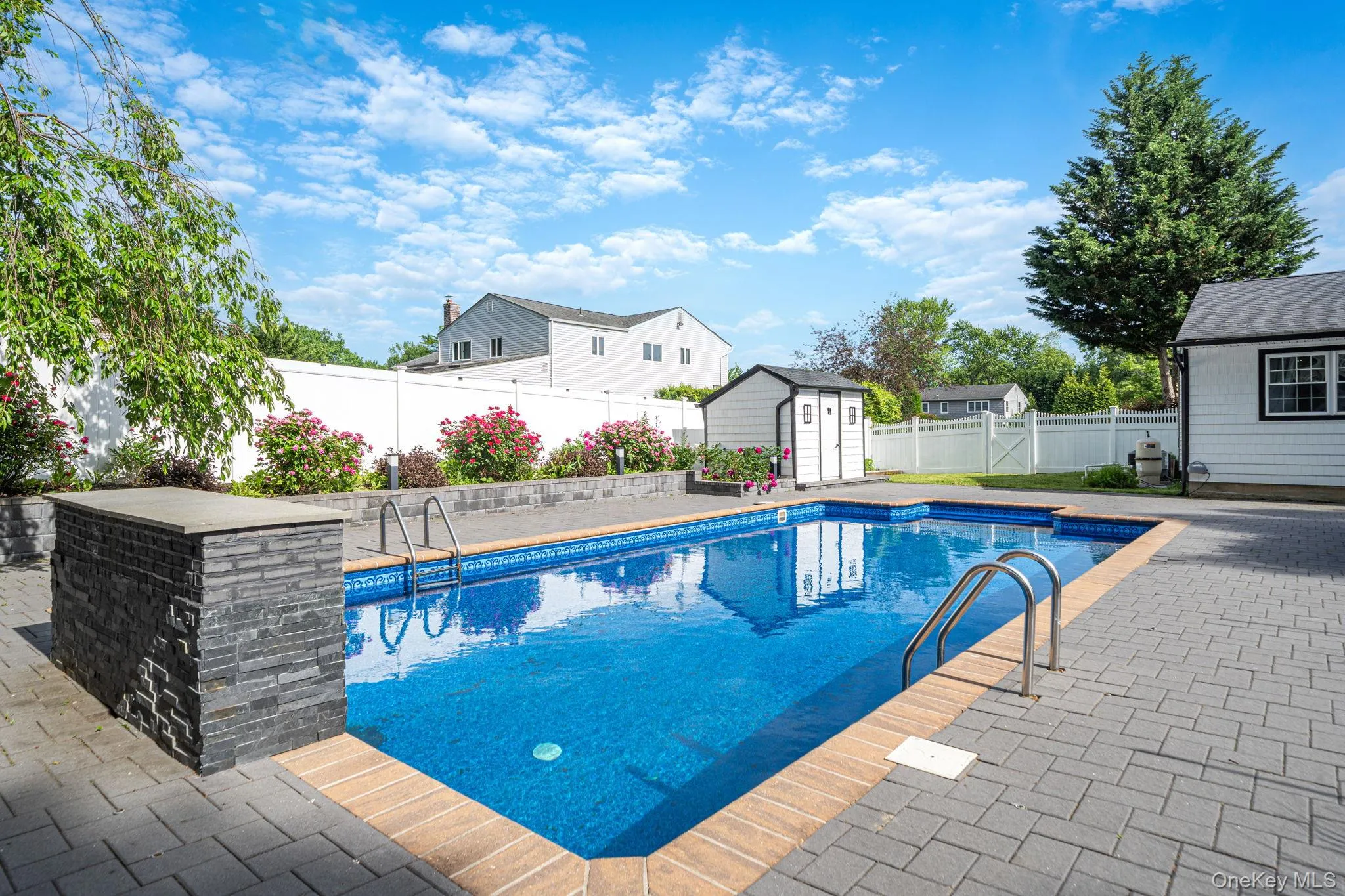 Inground salt water pool with lights and a fountain, expanded brick pool deck, beautiful landscaping, and shed. Inground salt water pool with lights and a fountain, expanded brick pool deck, beautiful landscaping, and shed.