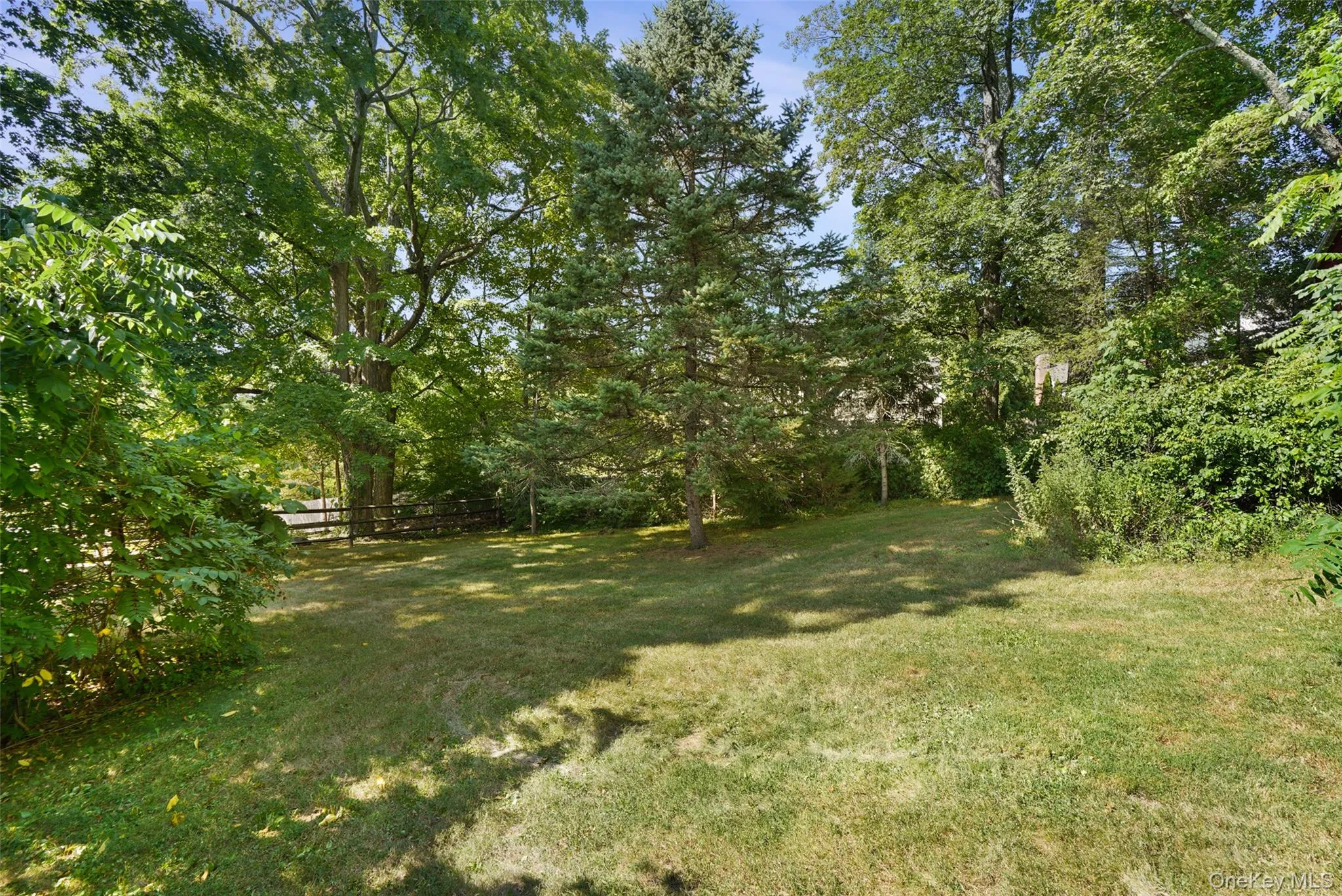 fenced yard across from private driveway fenced yard across from private driveway