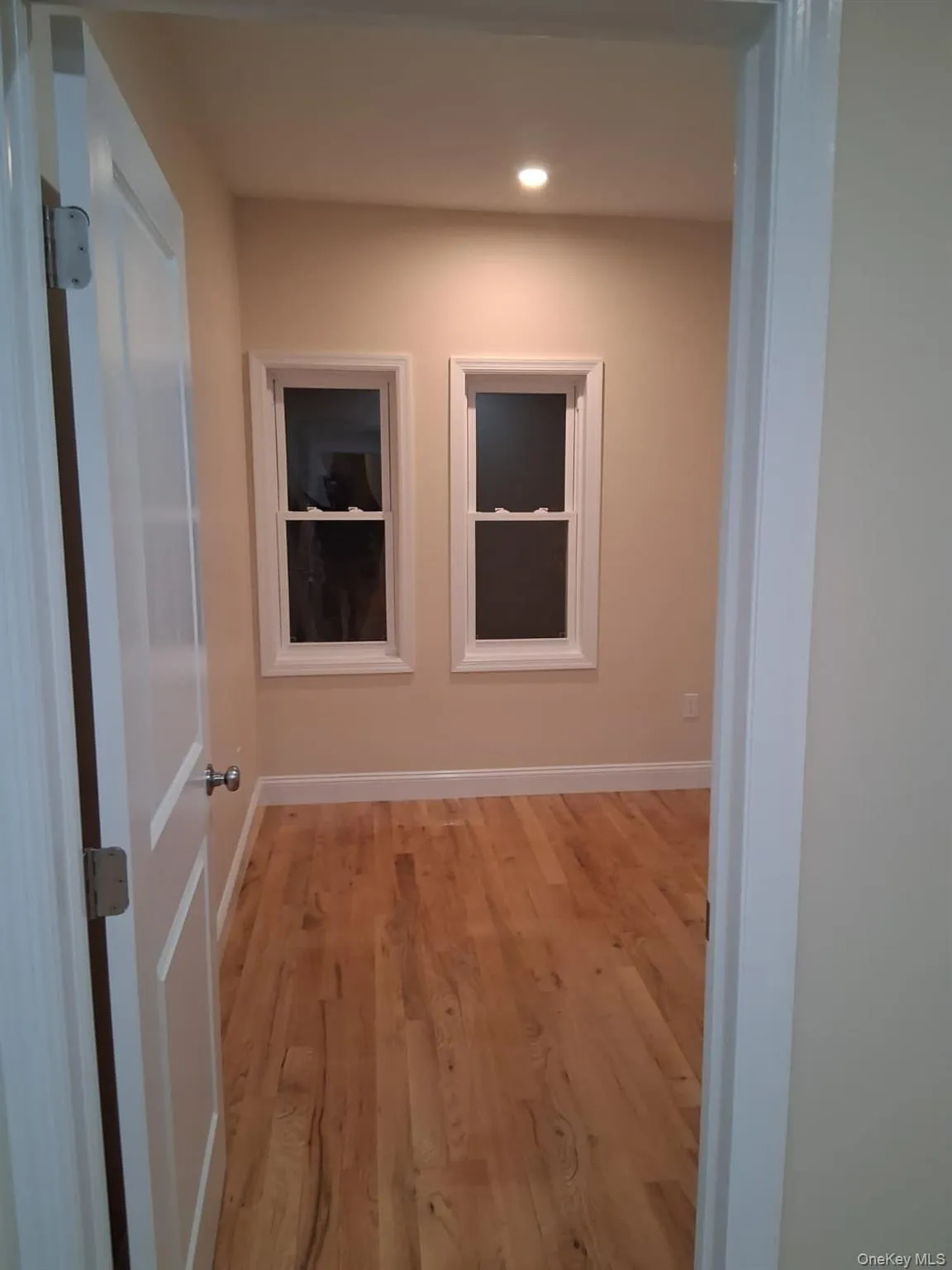 Hallway with light wood finished floors and recessed lighting Hallway with light wood finished floors and recessed lighting