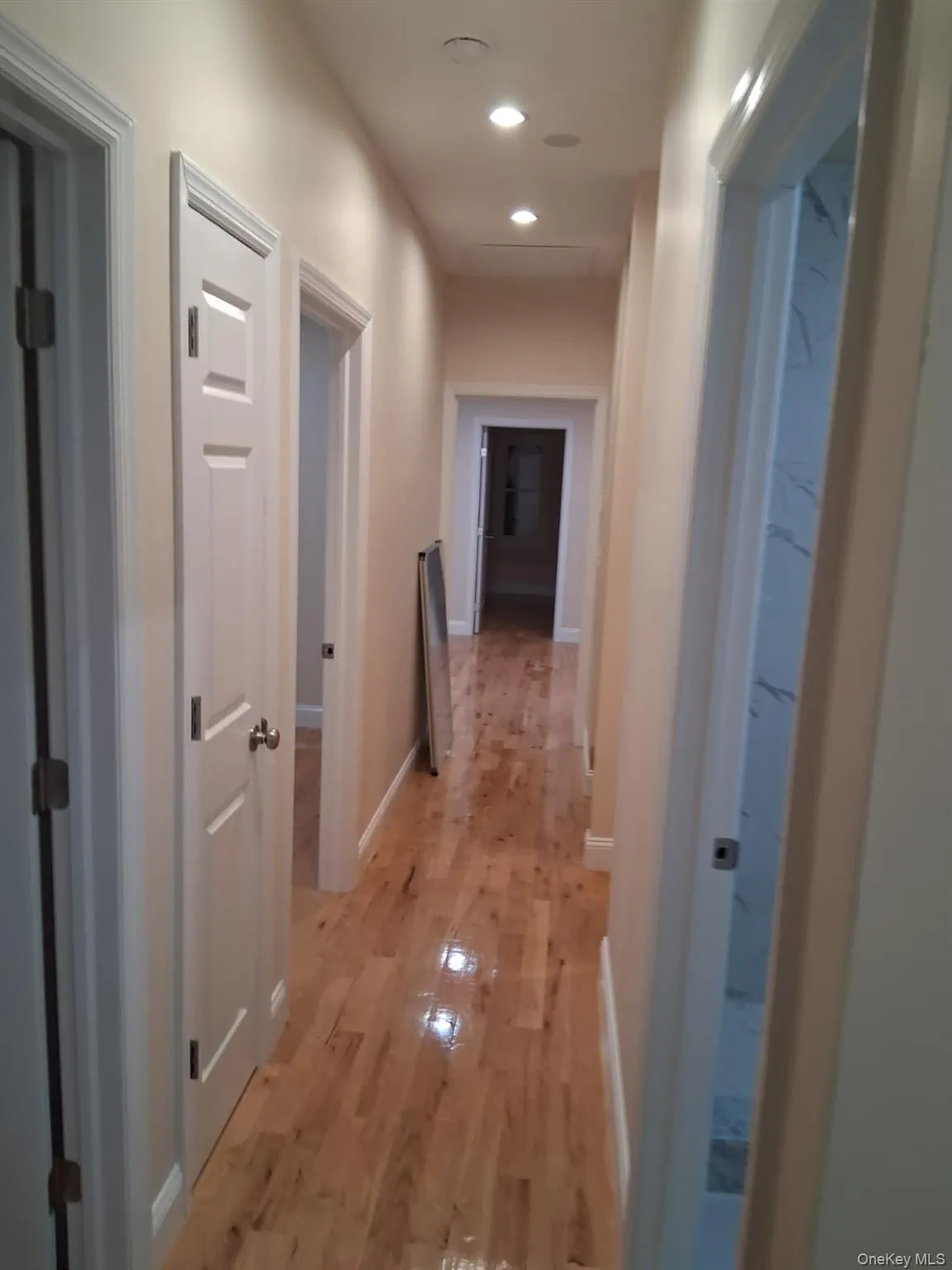 Corridor with recessed lighting and light wood finished floors Corridor with recessed lighting and light wood finished floors
