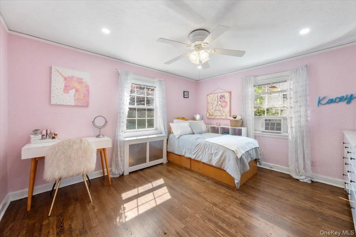 Sunny bedroom with Hardwood flooring complements the bright interior Sunny bedroom with Hardwood flooring complements the bright interior