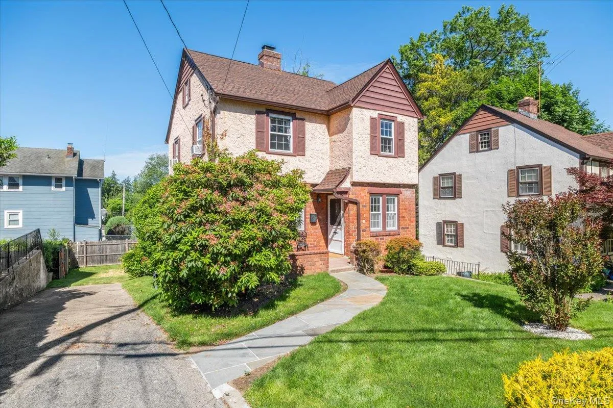 An attractive Tudor style home on a quiet residential street An attractive Tudor style home on a quiet residential street