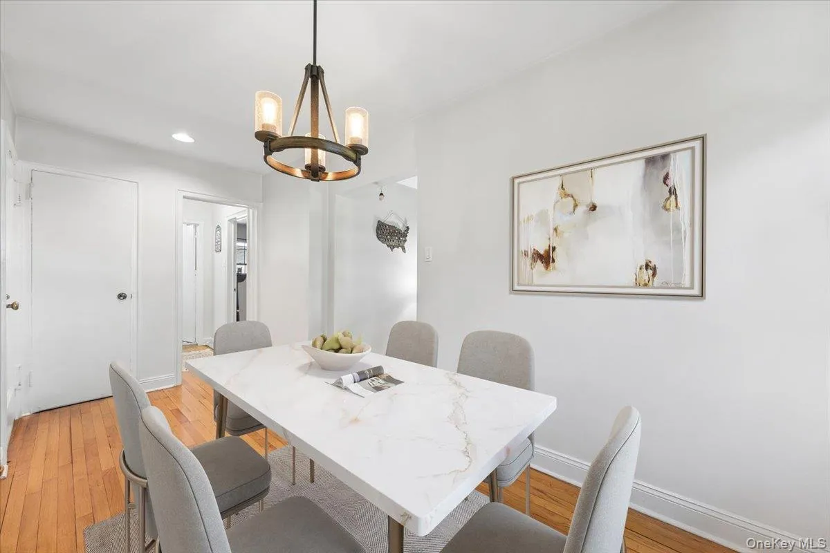 Dining area featuring a contemporary chandelier, recessed lighting, and wood-finish flooring (Virtually Staged) Dining area featuring a contemporary chandelier, recessed lighting, and wood-finish flooring (Virtually Staged)