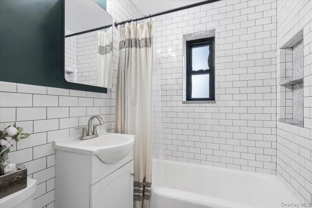 Renovated full hall bathroom includes a bathtub Renovated full hall bathroom includes a bathtub