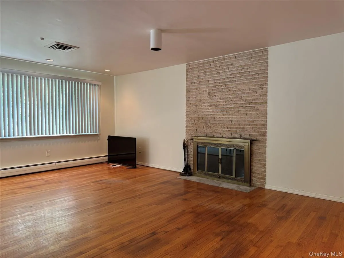 Family room with warm wood floors and fireplace Family room with warm wood floors and fireplace