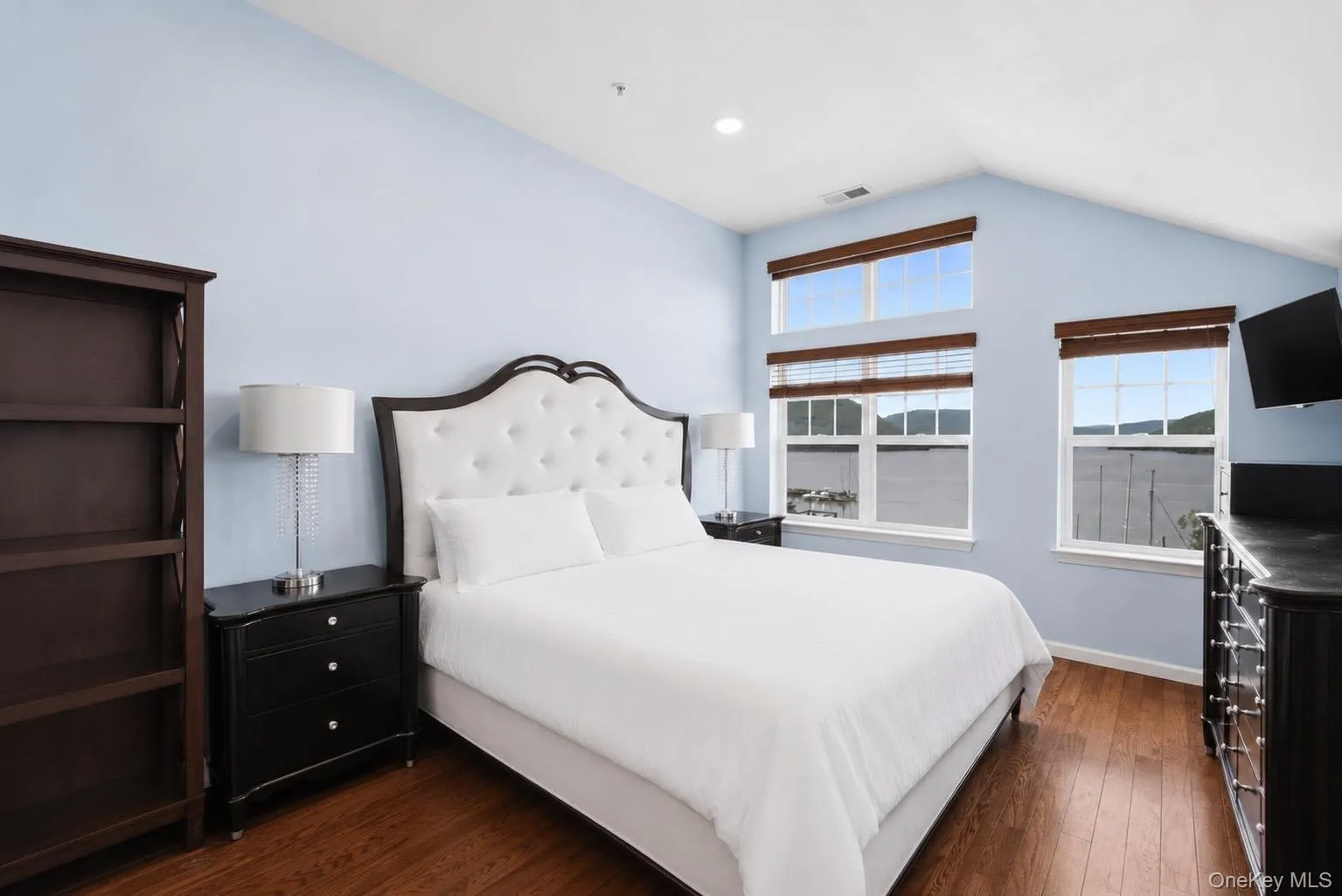 Primary bedroom has vaulted ceiling, new recessed lights, walk-in closet, HWF, and a large window array with views of the Hudson River and Bear Mountain Primary bedroom has vaulted ceiling, new recessed lights, walk-in closet, HWF, and a large window array with views of the Hudson River and Bear Mountain