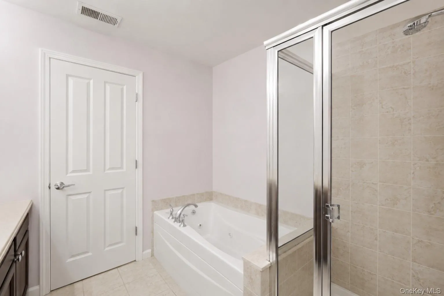 Primary Bathroom featuring a built-in jetted tub, and a separate shower. Primary Bathroom featuring a built-in jetted tub, and a separate shower.