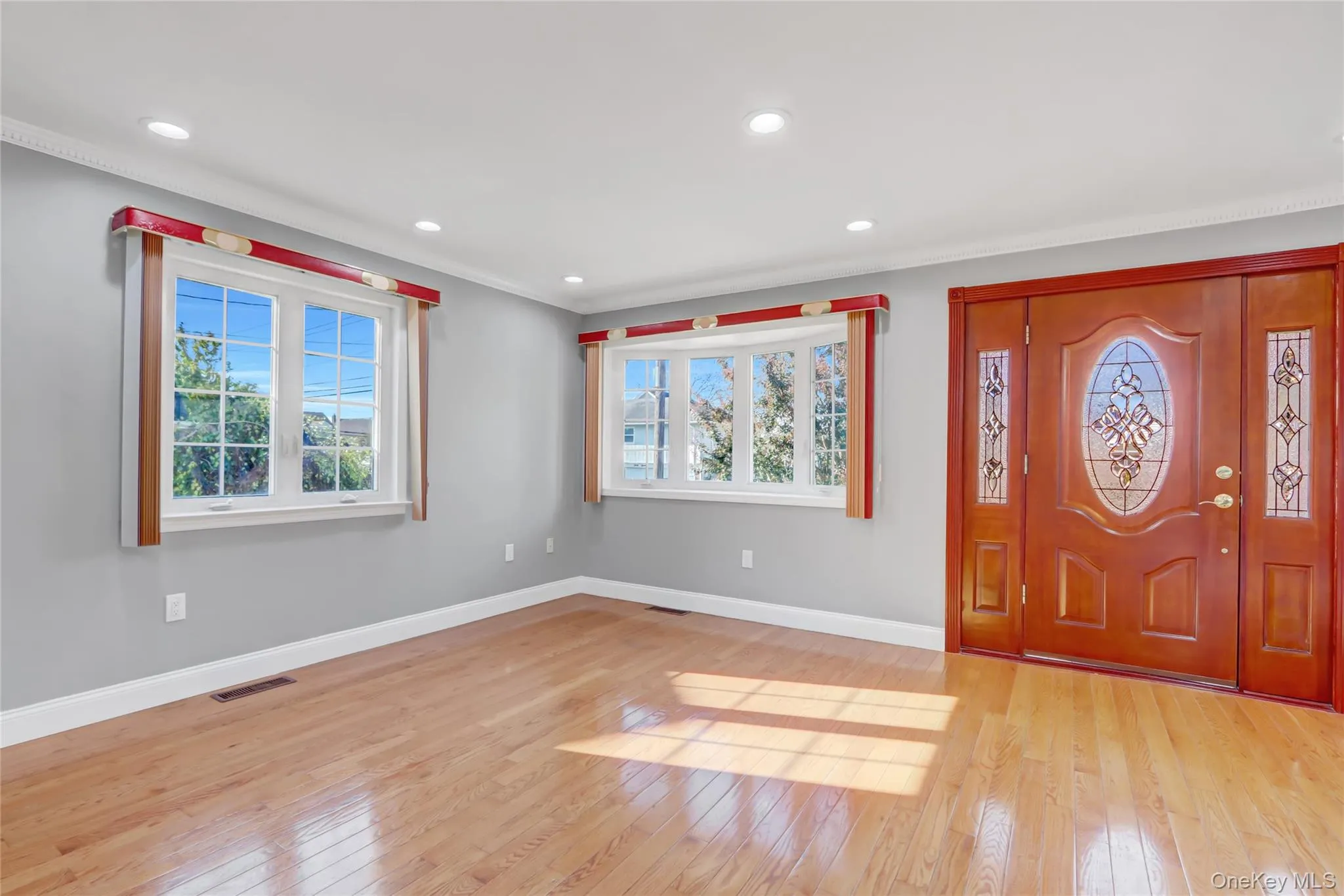 Large wooden door with decorative glass inserts and sidelights Large wooden door with decorative glass inserts and sidelights